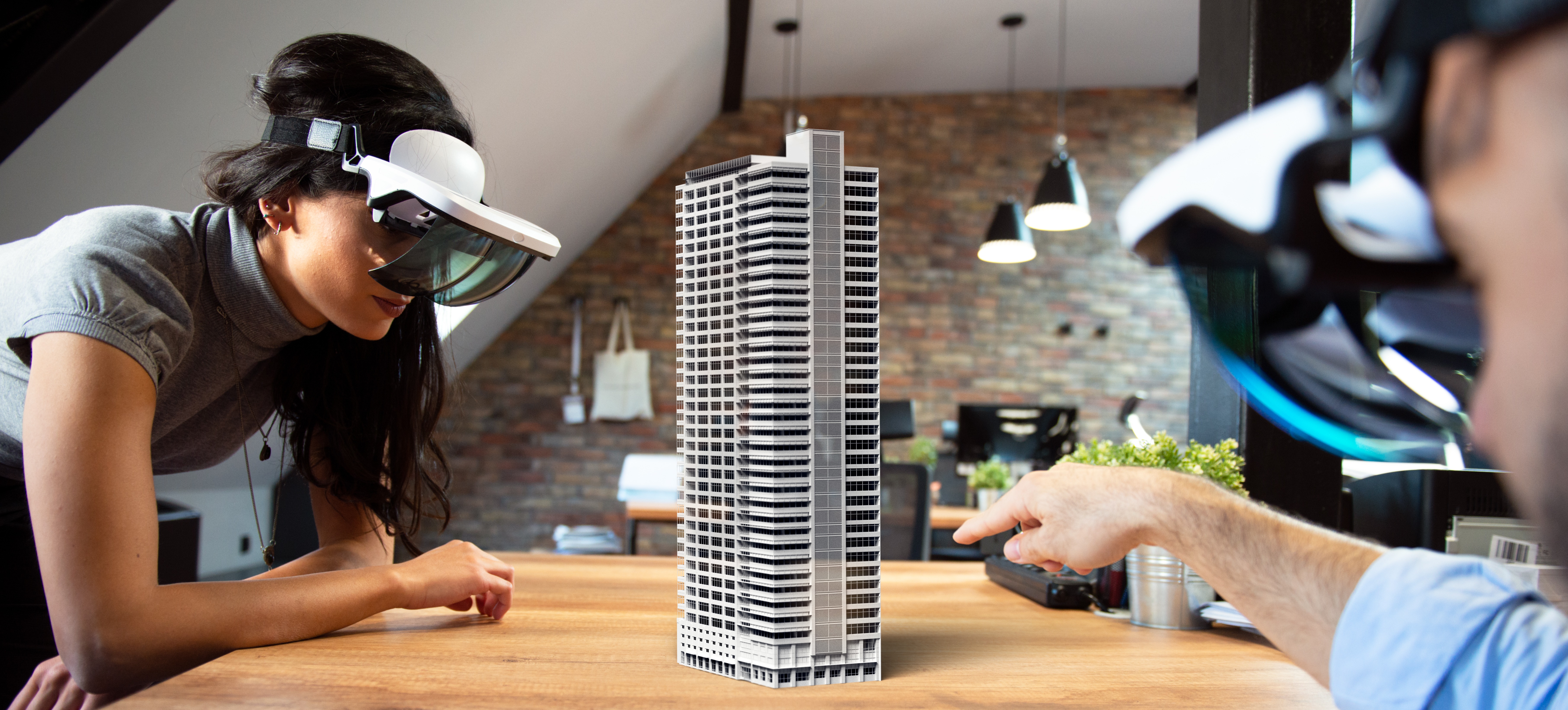 [Featured Image] Two architects are using AR skills to create a 3D prototype of a building project.
