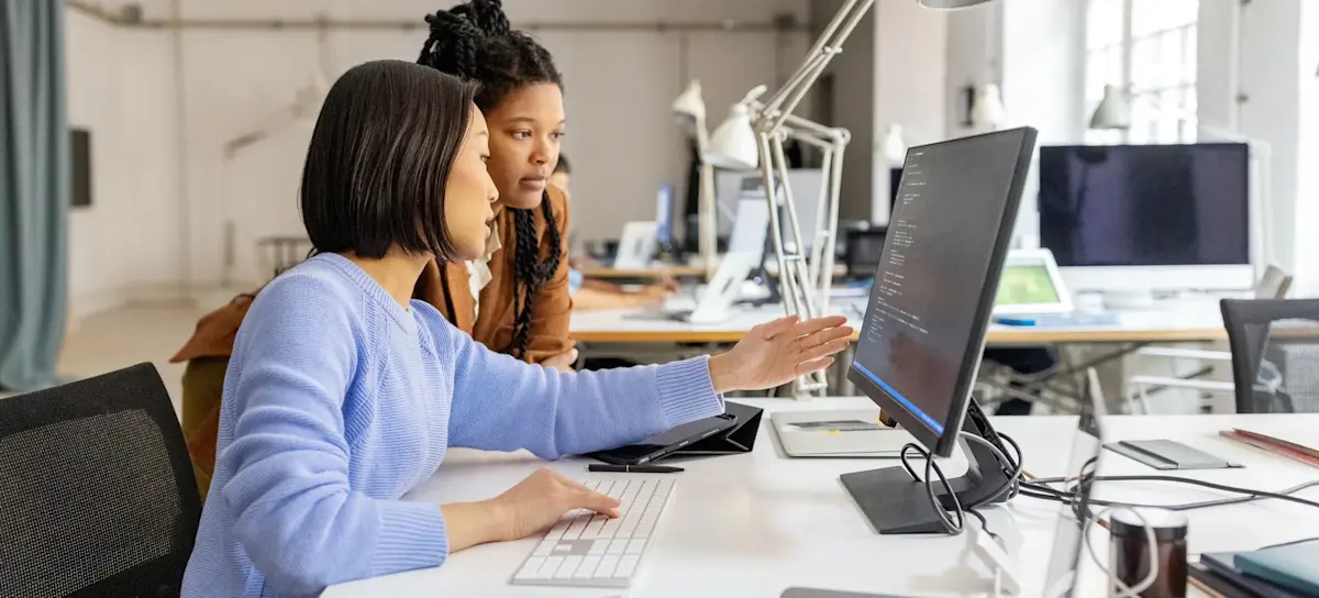 [Featured Image] A mentor explains GraphRAG and its benefits for AI applications to a colleague preparing to join a project team. 
