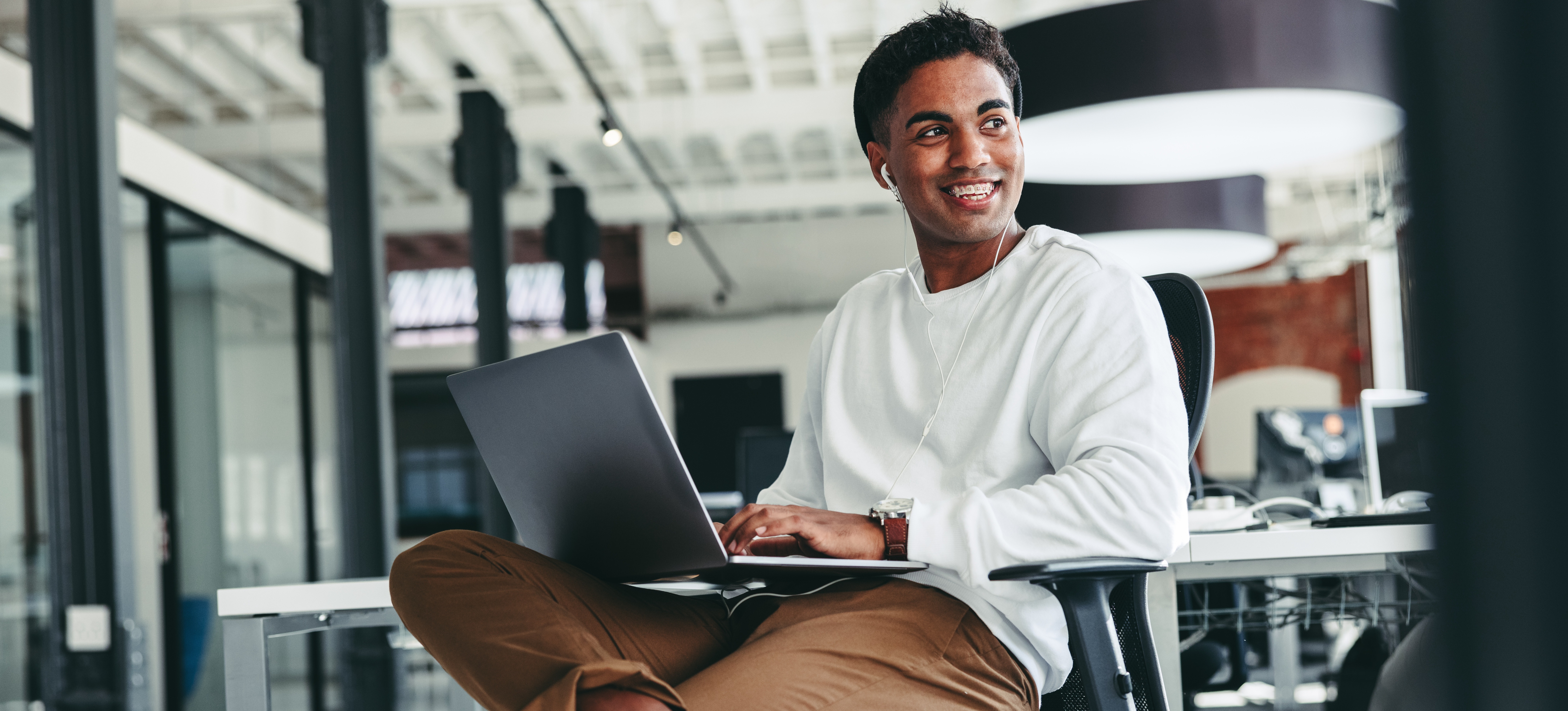 [Featured Image] A person works on a laptop computer in an office.