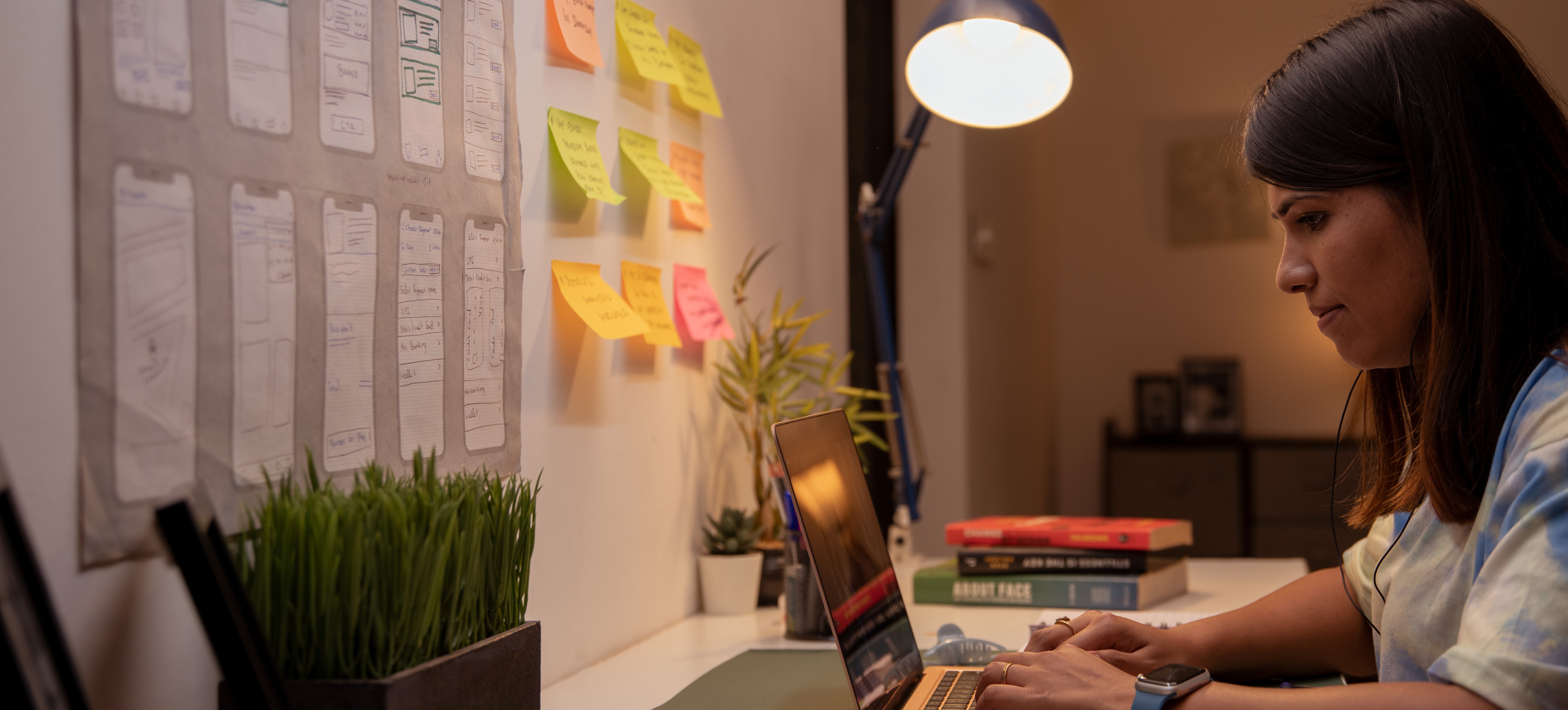 [Featured Image] A graduate student earning a master's in IT management is studying at their desk and looking at their computer. 