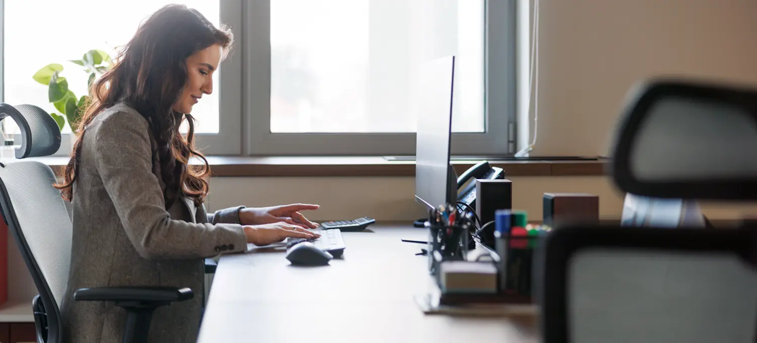 [Featured image: A business professional at their computer, using a Google Analytics cohort analysis to gain insights into consumer behavior.]
