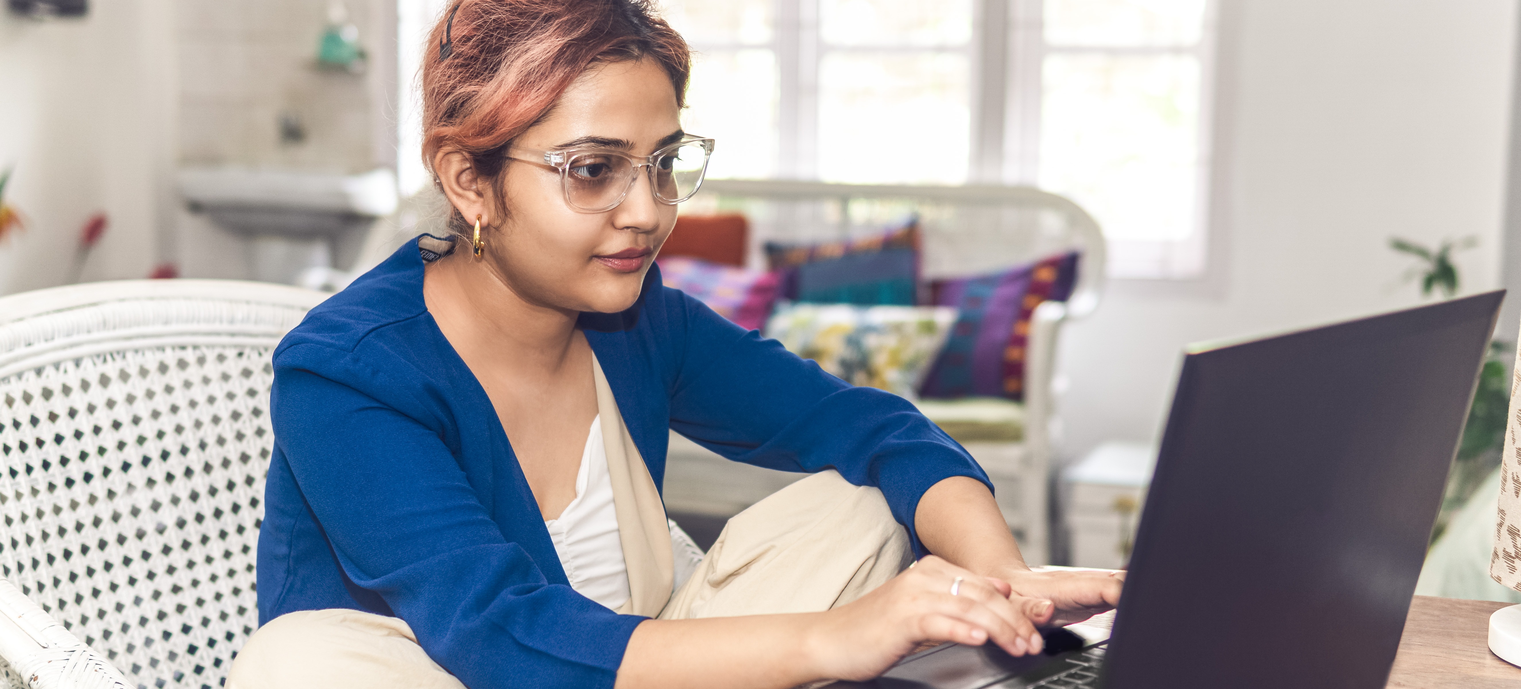 [Featured Image] A young learner researches “What is load balancing?” whilst working on their website development lessons. 

