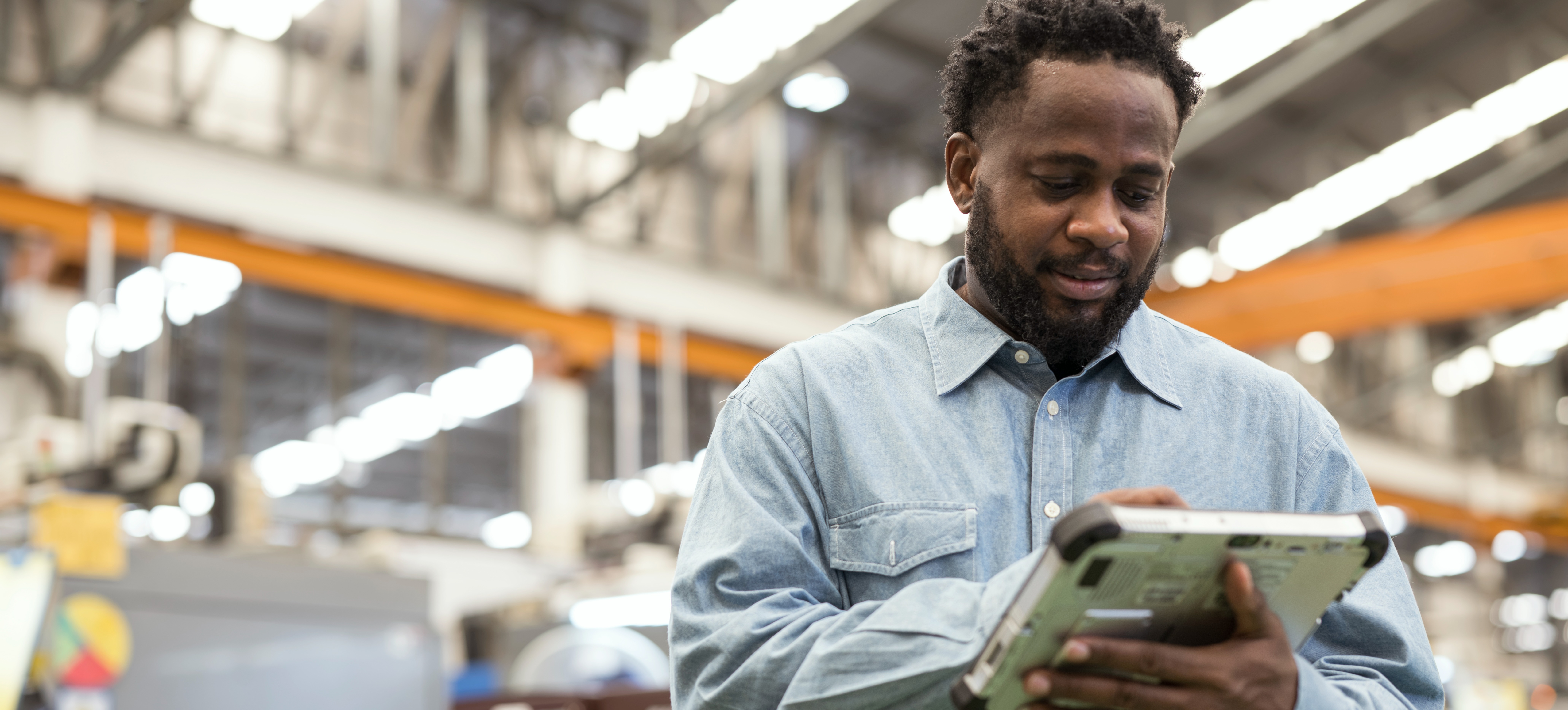 [Featured Image] A warehouse manager uses smart warehouse technology to monitor operational efficiency.
