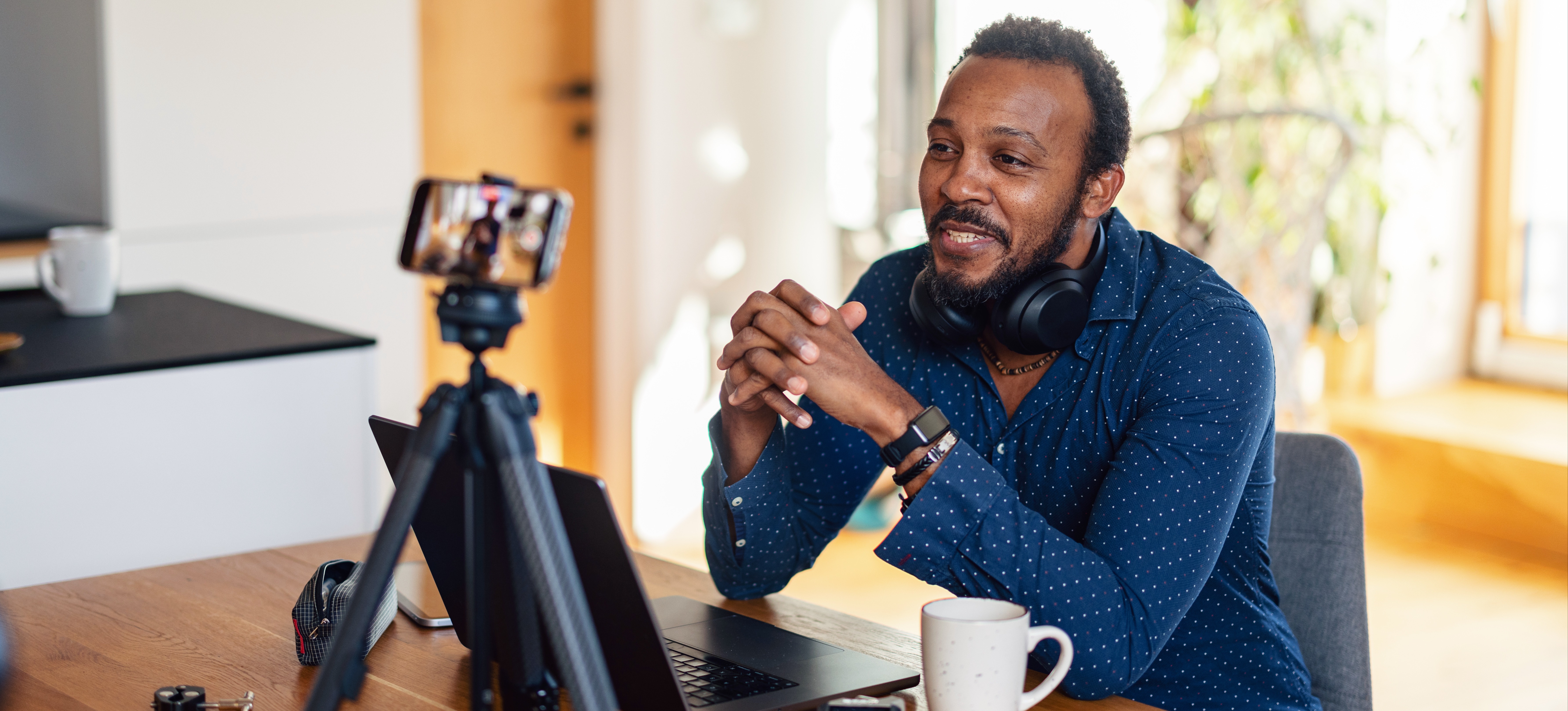 [Featured Image] A content creator records audio and video to help reach his target audience.
