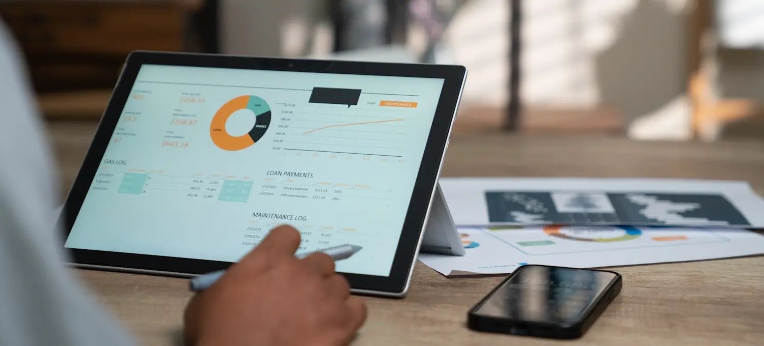 [Featured image] A business intelligence engineer looks at an analytics dashboard on a tablet.