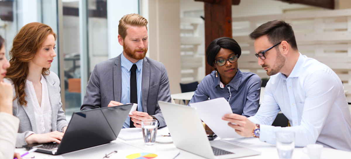 [Featured Image] A team of financial analysts reviews an organization’s capital intensity ratio to assess its financial efficiency.
