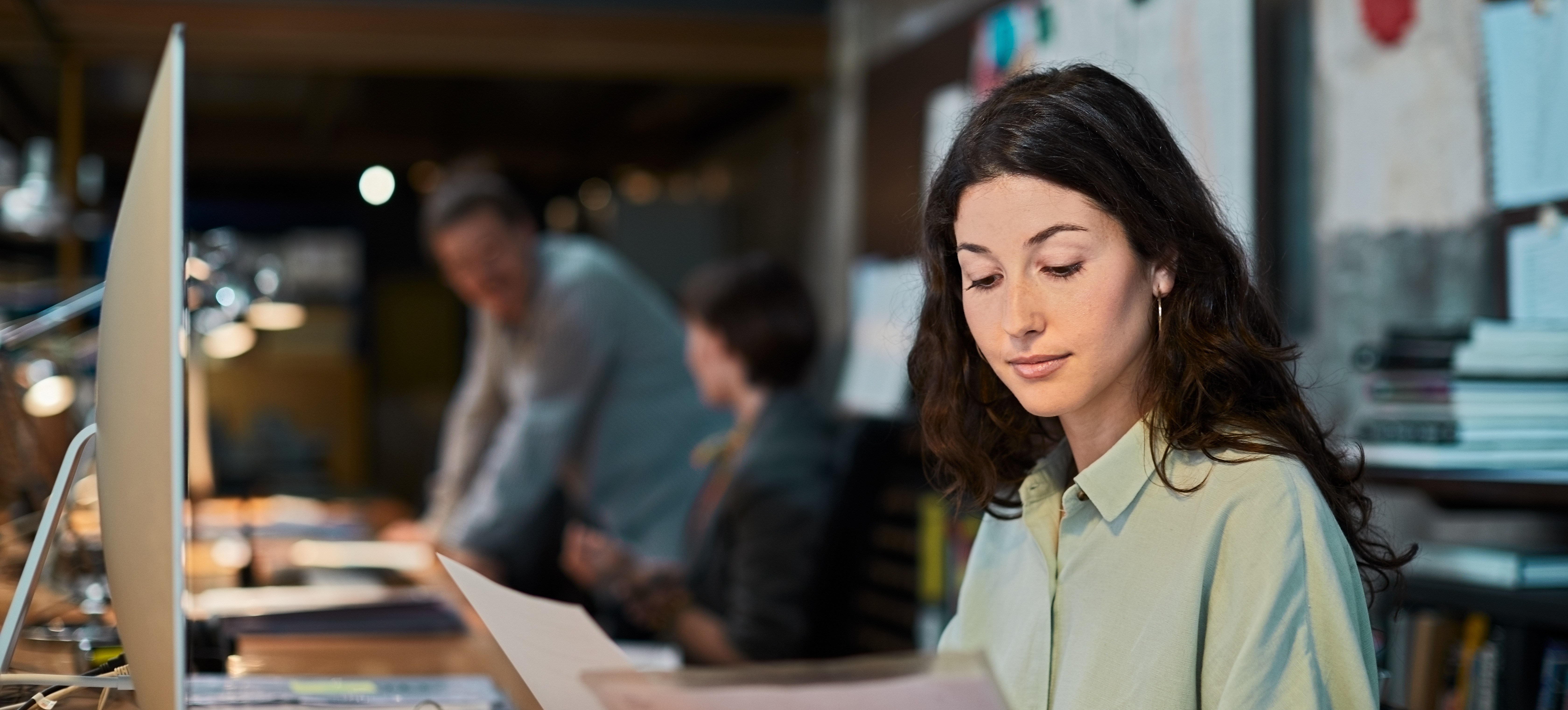 [Featured Image] A Power BI specialist analyzing documents in a professional workspace, focusing on data insights and improving Power BI skills.