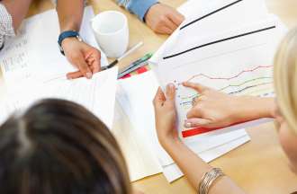 [Featured image] A project management team looks at a burndown chart for a project.