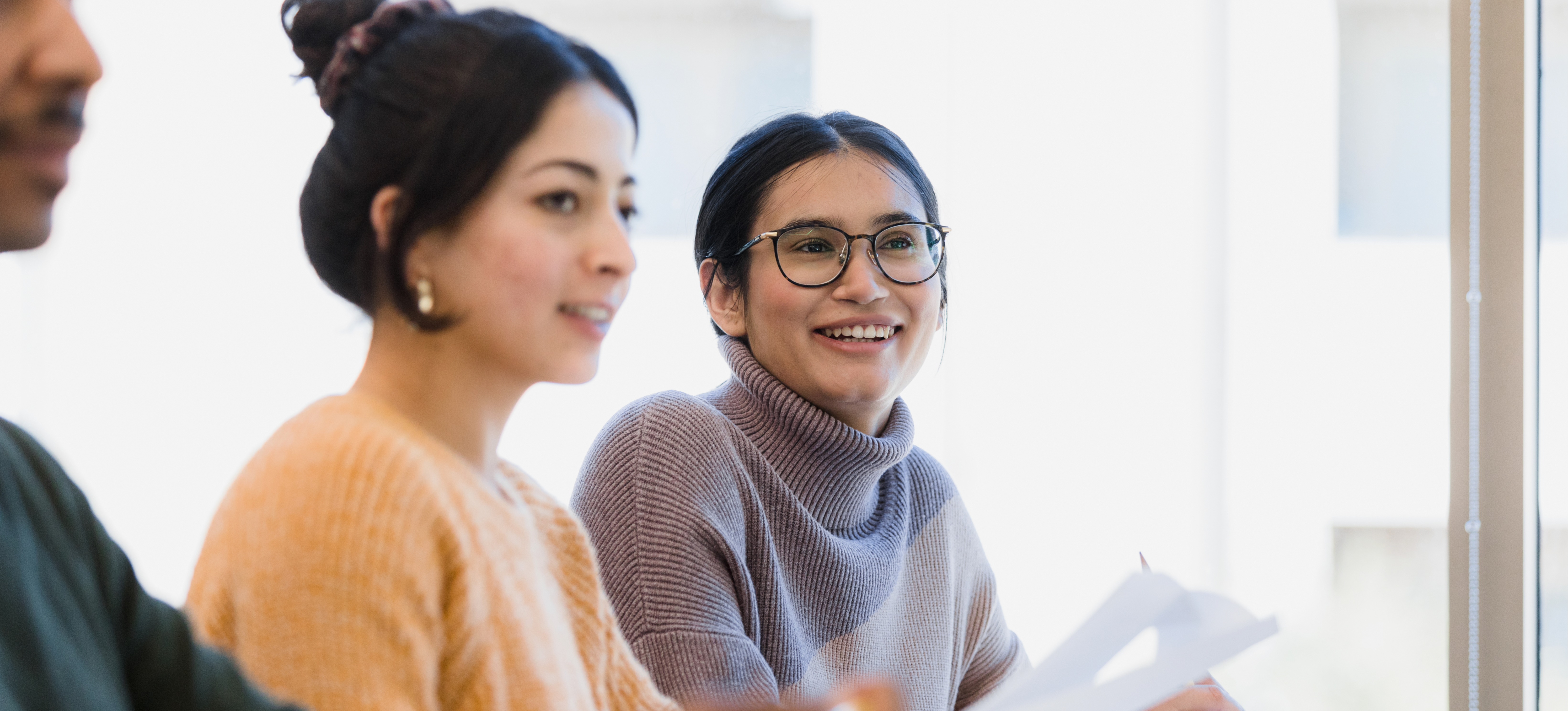 [Featured Image] Two college students sit in an introduction to data science college class. 