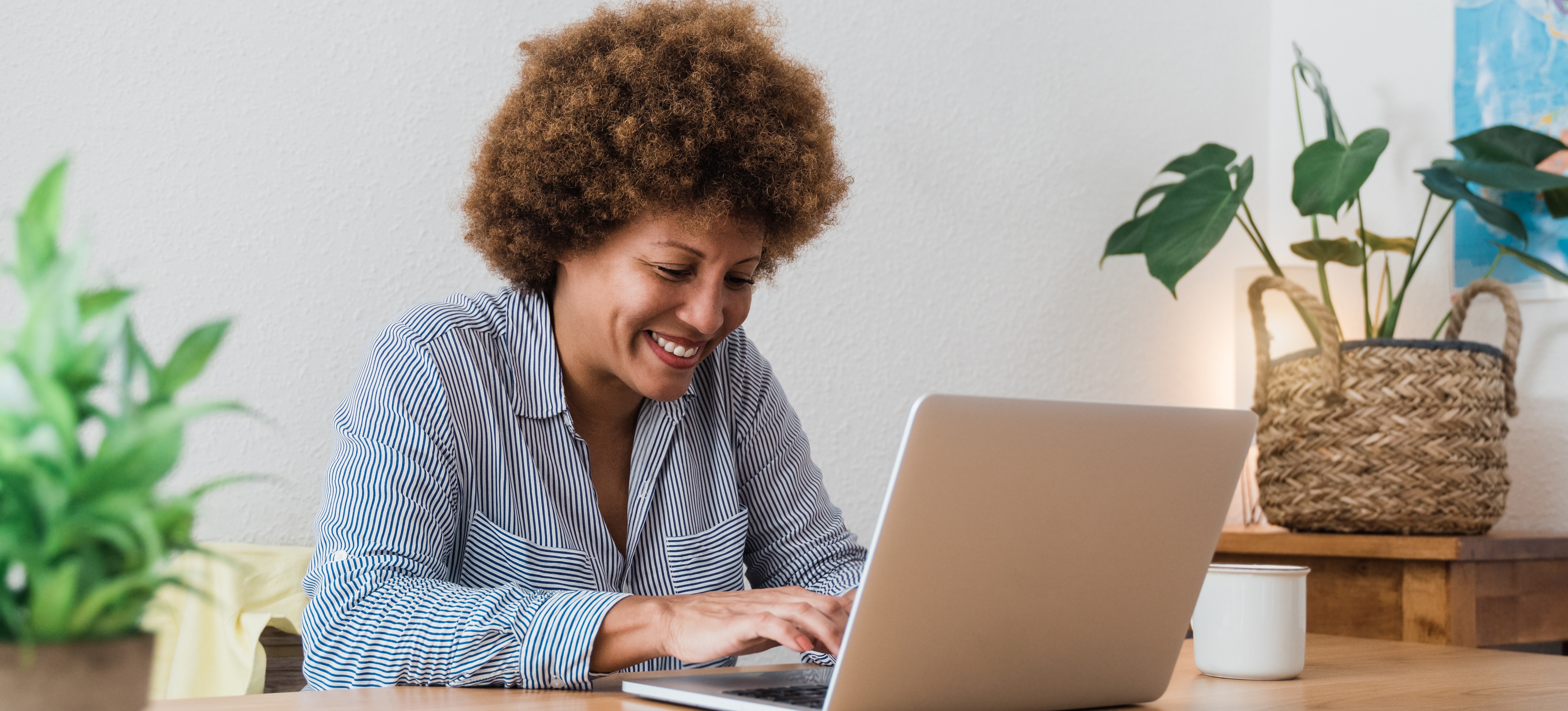 [Featured Image] A cybersecurity marketing professional sits at a laptop and focuses on lead generation.  
