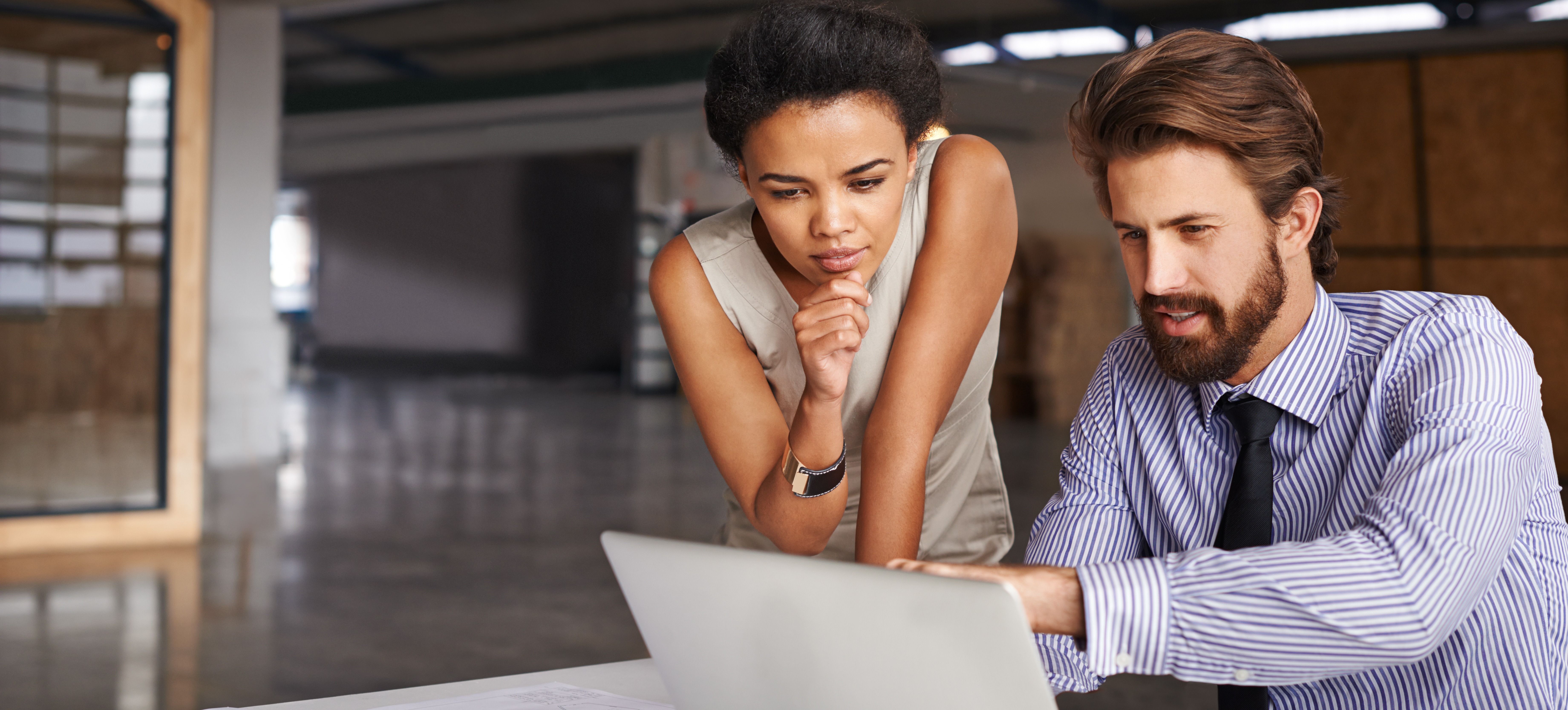 [Featured image]: A software architect at a computer, communicating their ideas with a member of the development team
