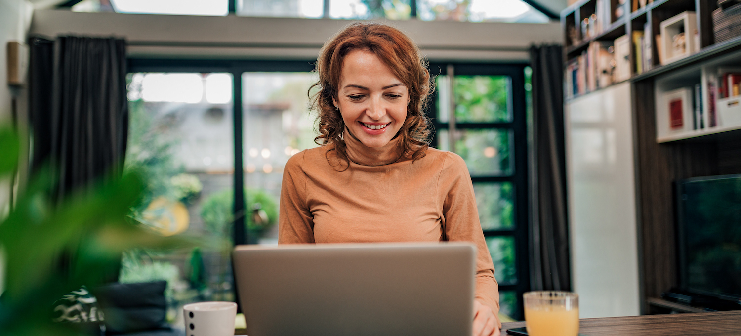 [Featured image] A person wearing an orange turtleneck sits at home in front of a laptop, working on a job application email.