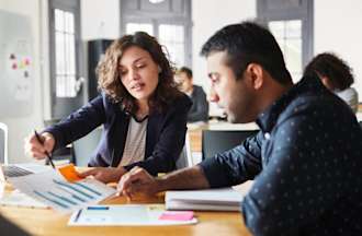 [Featured image] A marketing analyst gives a presentation to her business team on her findings