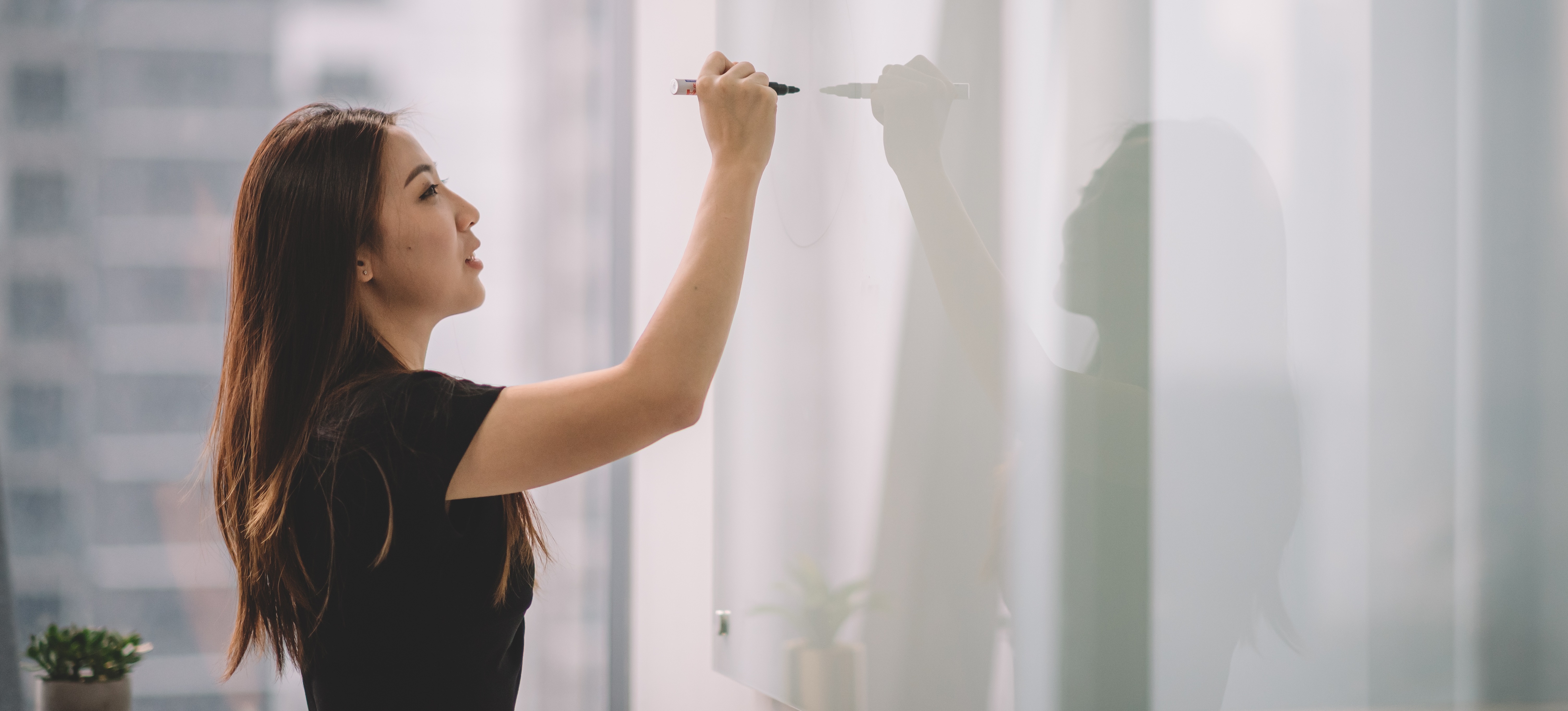 [Featured Image] A design manager explains a new project to a design management team.
