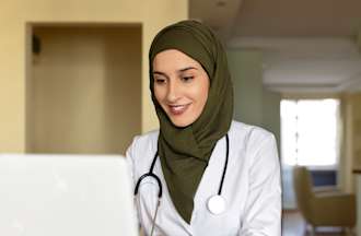 [Featured image] Nurse at a computer