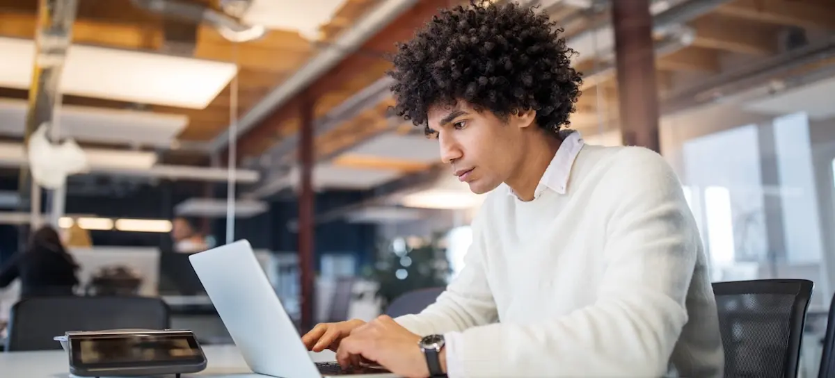 [Featured image] A person in an office looks at his laptop, researching whether they can earn a master's in computer science without a CS undergrad degree.