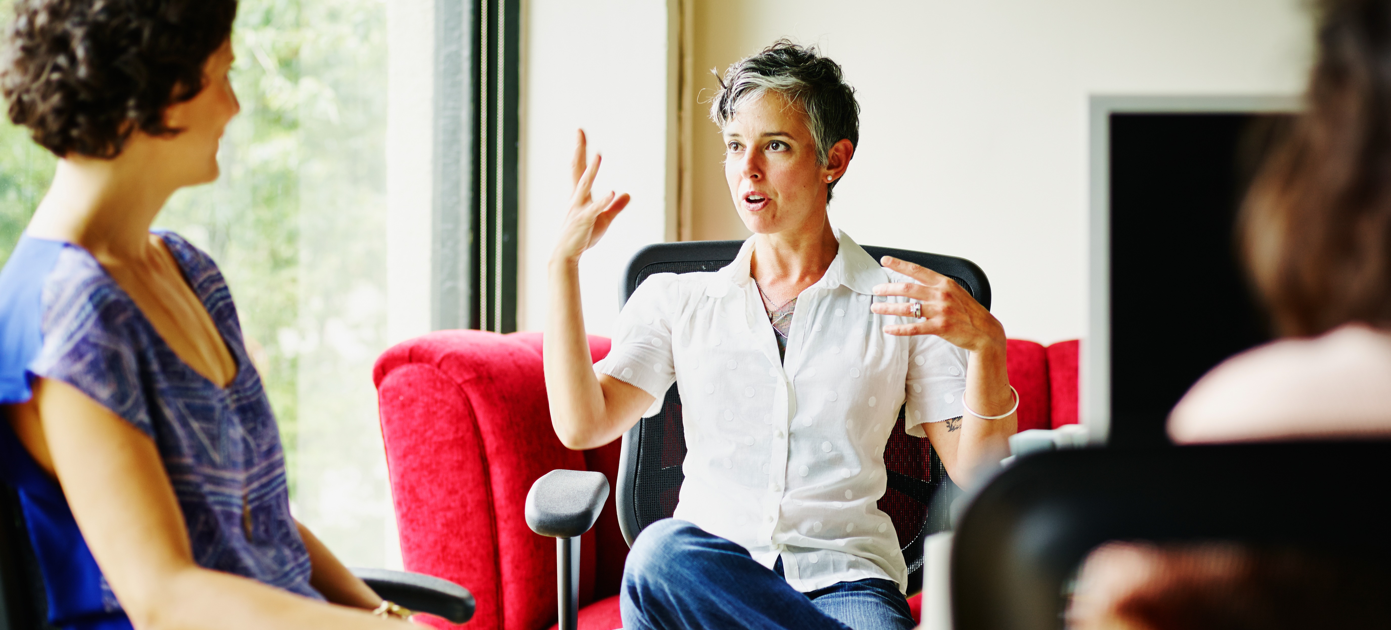 [Featured Image] A manager is conducting a business meeting with their direct reports.
