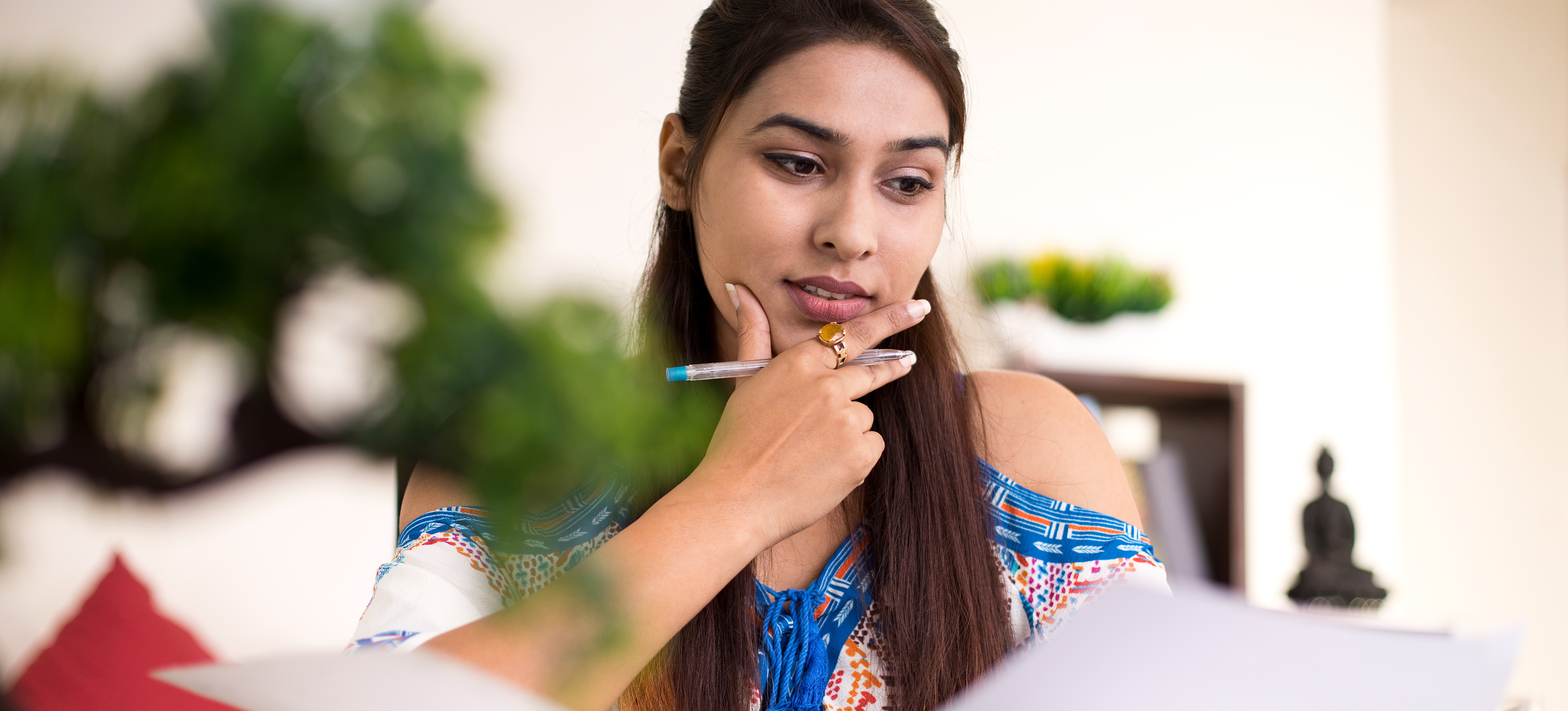 [Featured image] A person is looking at papers contemplating if they need an associate degree to get a bachelor's.