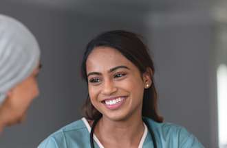 [Featured Image]:  Advance Practice Registered Nurse,  consulting with a patient. 