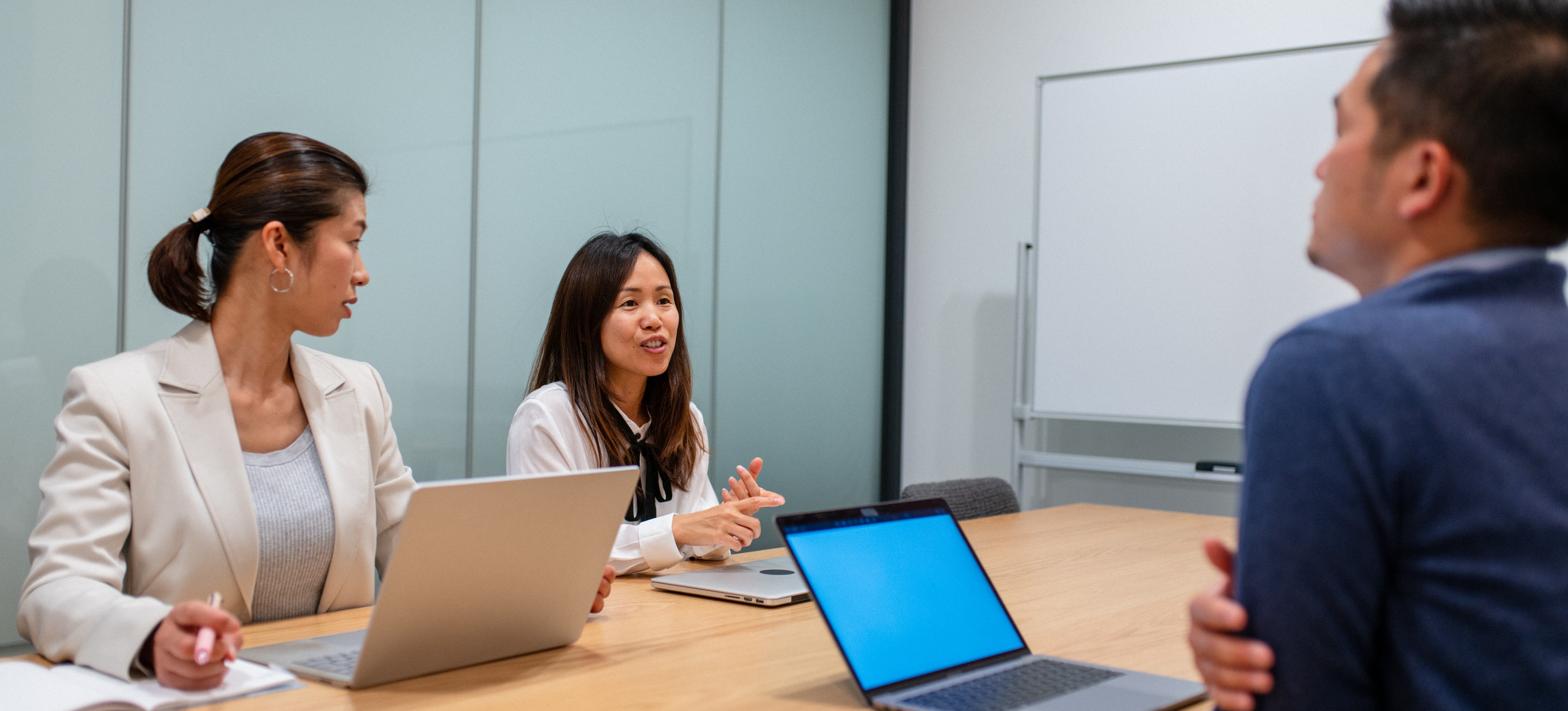 [Featured Image] An interview takes place in a conference room within a professional office environment, where colleagues ask the applicant MATLAB interview questions. 
