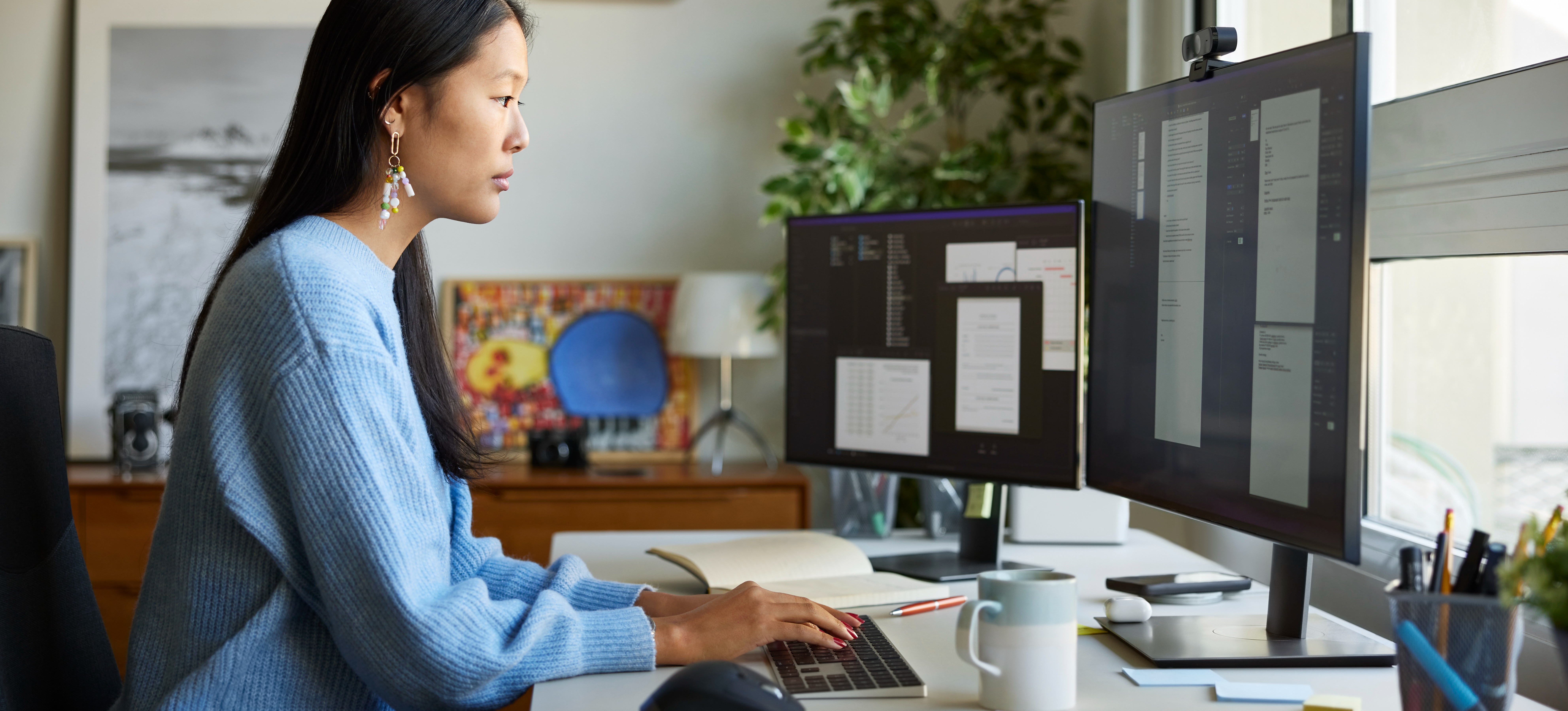 [Featured image] A programmer analyst works at their computer workstation in an office.