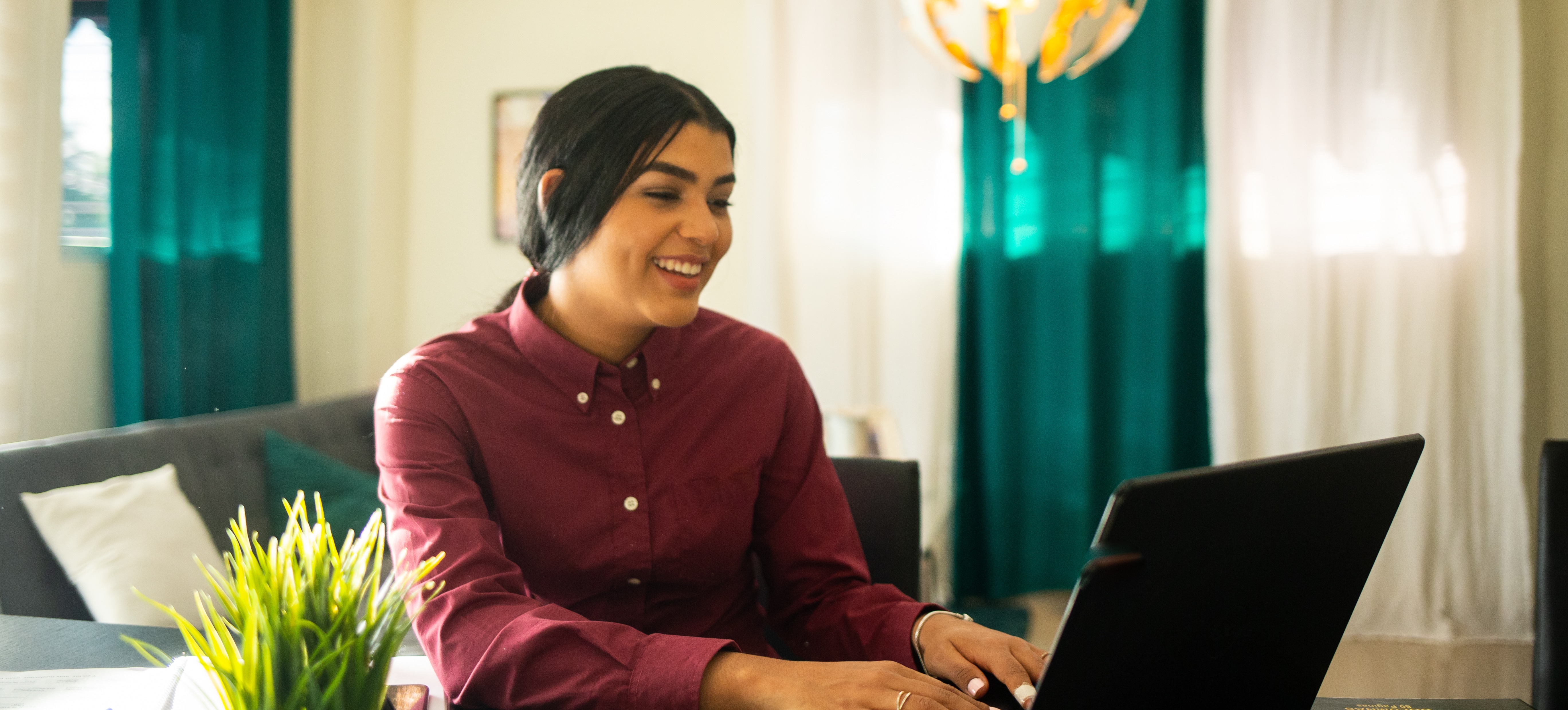 [Featured Image]: A young student uses a laptop to research cloud computing salary ranges as they explore career options.
