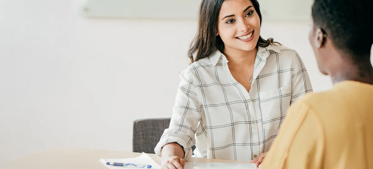 [Featured Image] An HR representative provides a new hire with the company’s compensation definition and details about their compensation packages.