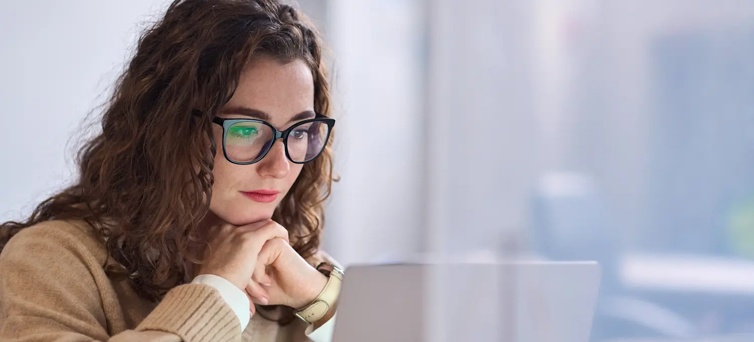 [Featured Image] A person focused intently on their computer, studying for the GMAT.
