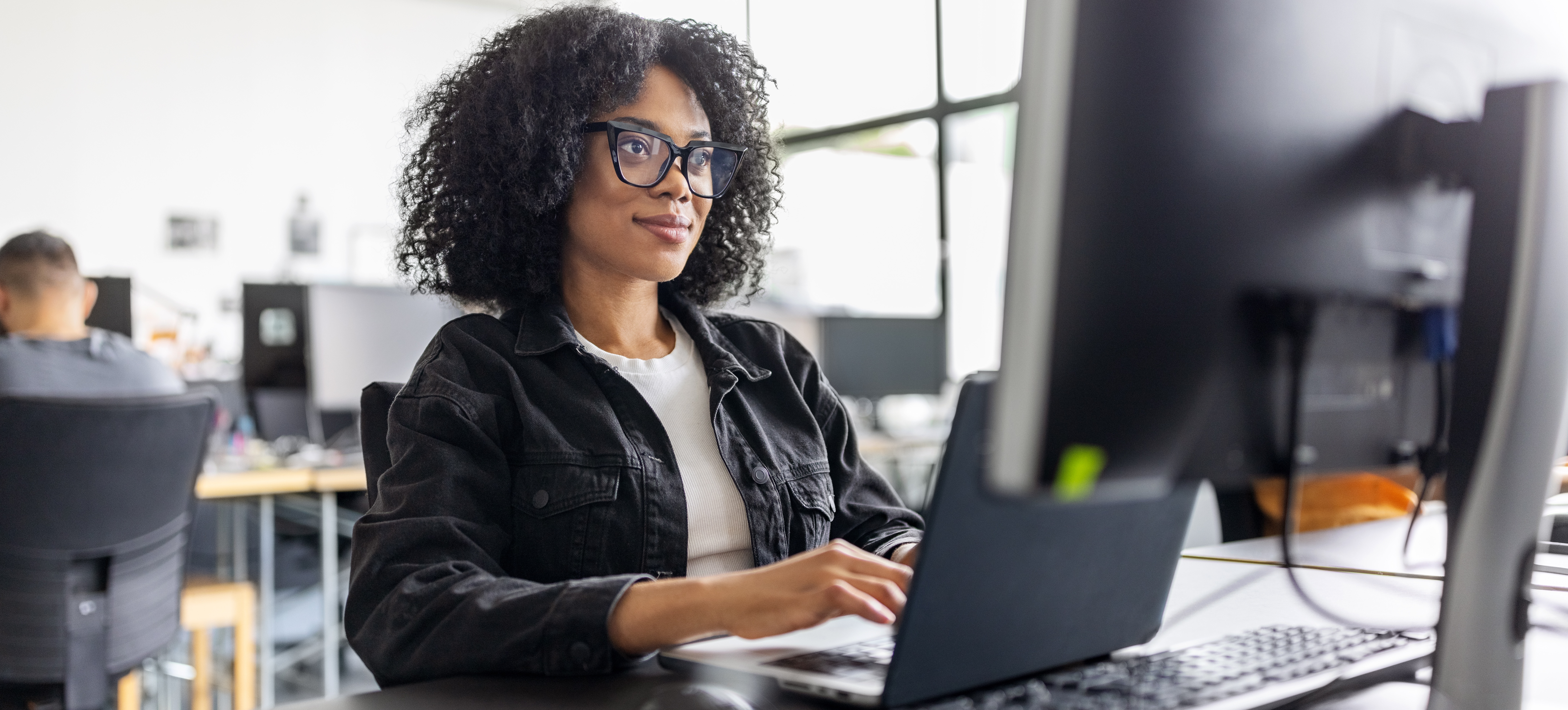 [Featured image] A businessperson at a computer, using Google Sheets data validation to ensure their spreadsheet data is accurate.
