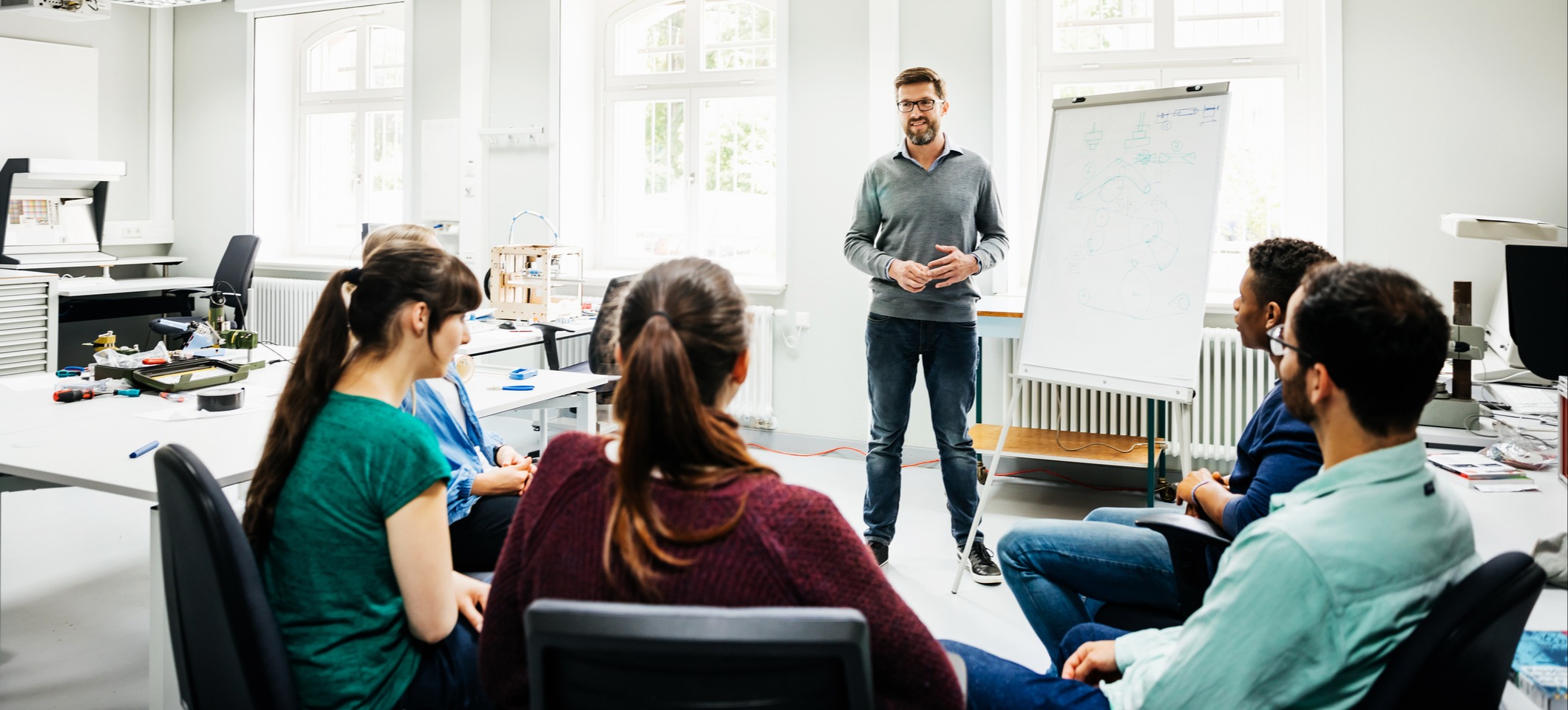 [Featured Image] A person who earns a learning and development specialist salary leads a small group training exercise.