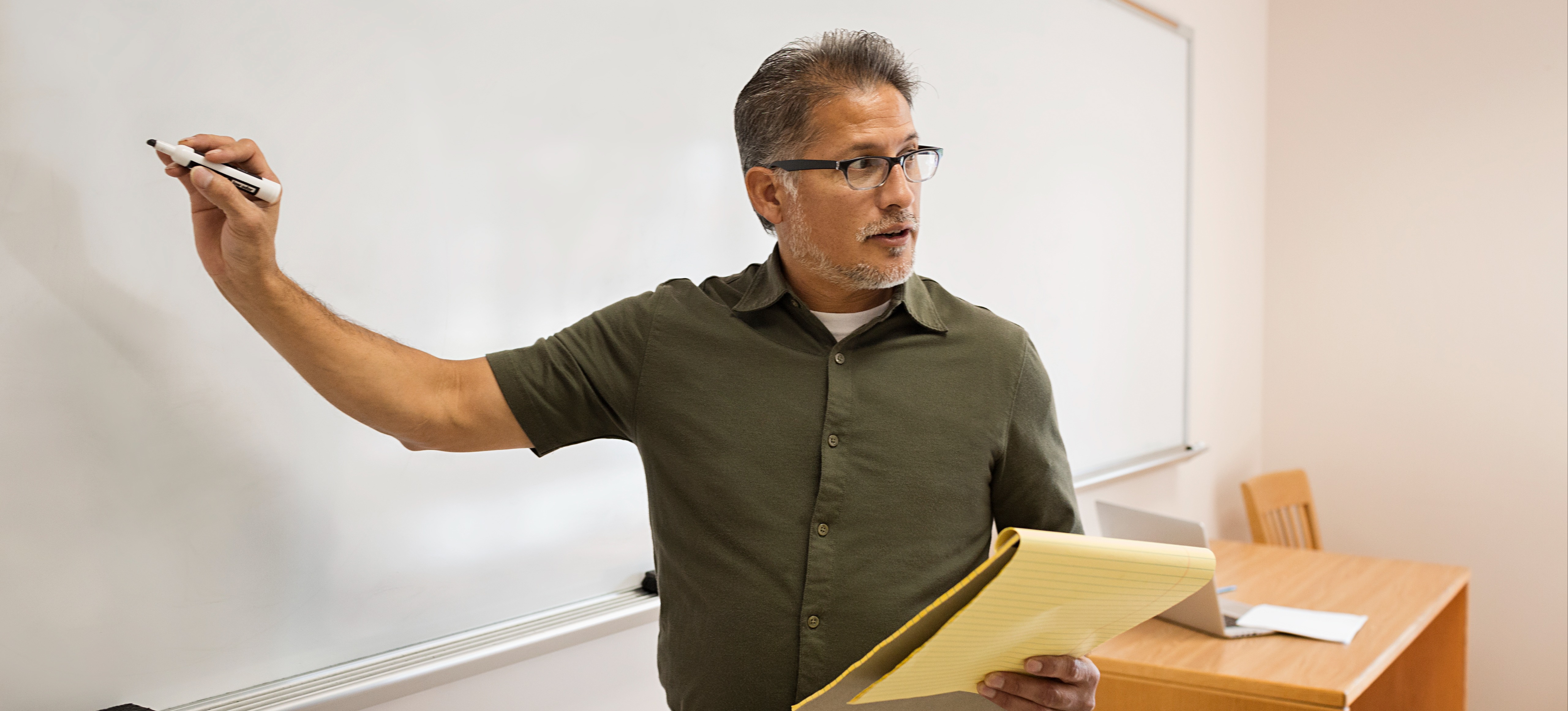 [Featured Image] A college professors discusses the future of AI in education with his classroom.