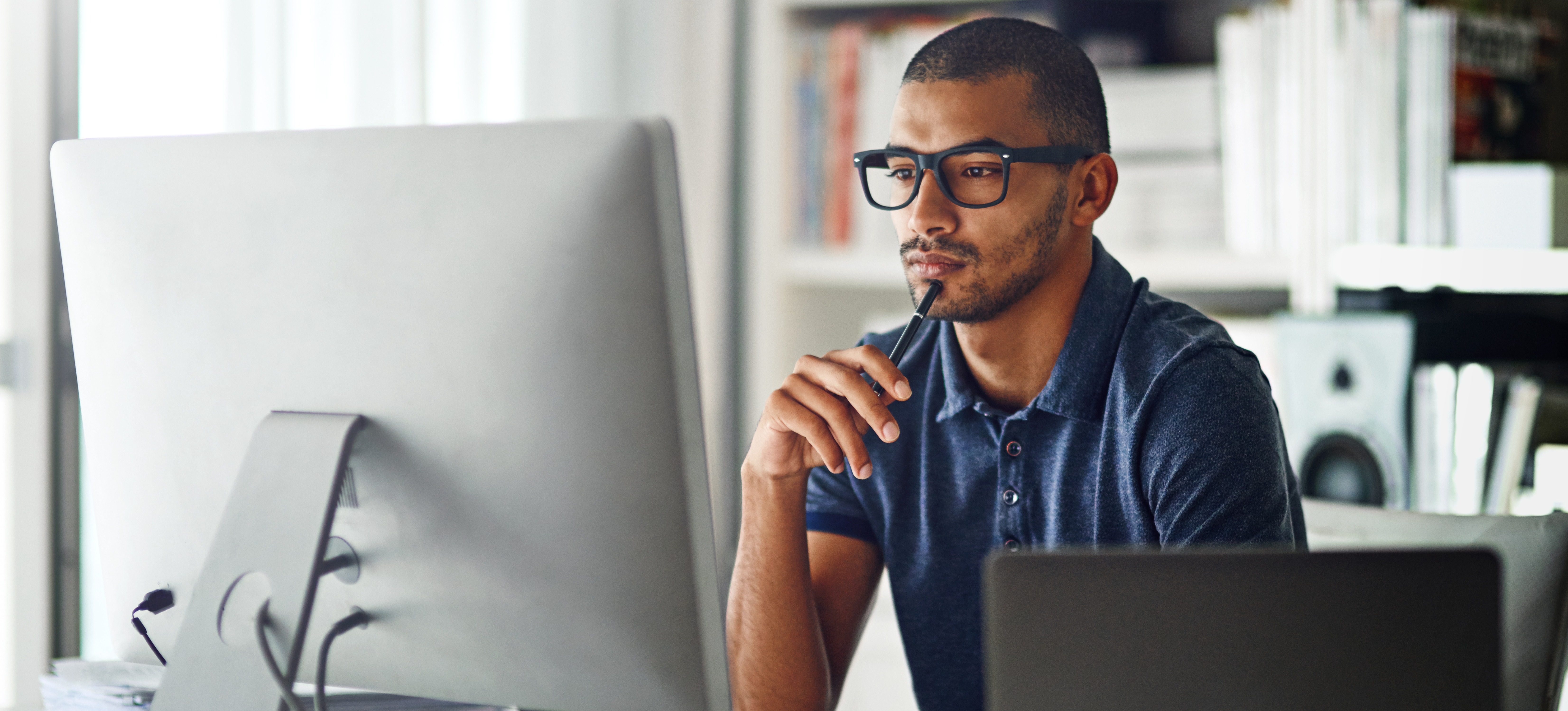 [Featured Image] A programmer sits at their office desk and studies deep learning frameworks on their computer.
