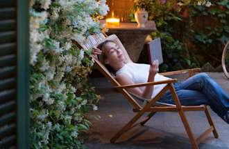 [Featured image] An IT support specialist is sitting outside on a lounge chair reading about PGP on their tablet. 