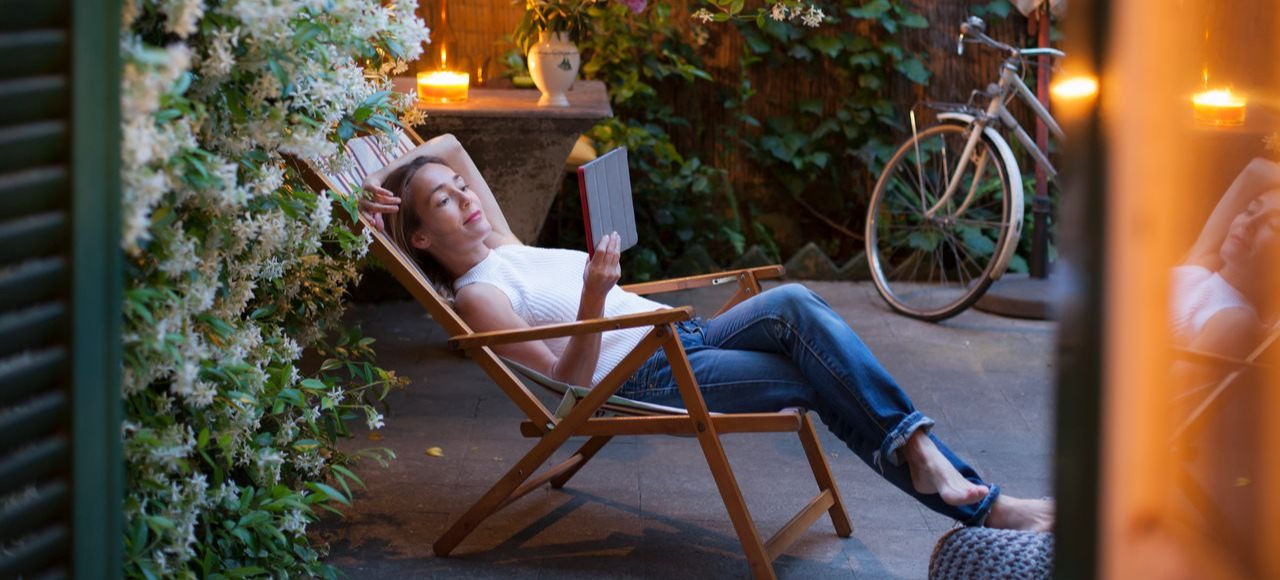 [Featured image] An IT support specialist is sitting outside on a lounge chair reading about PGP on their tablet. 