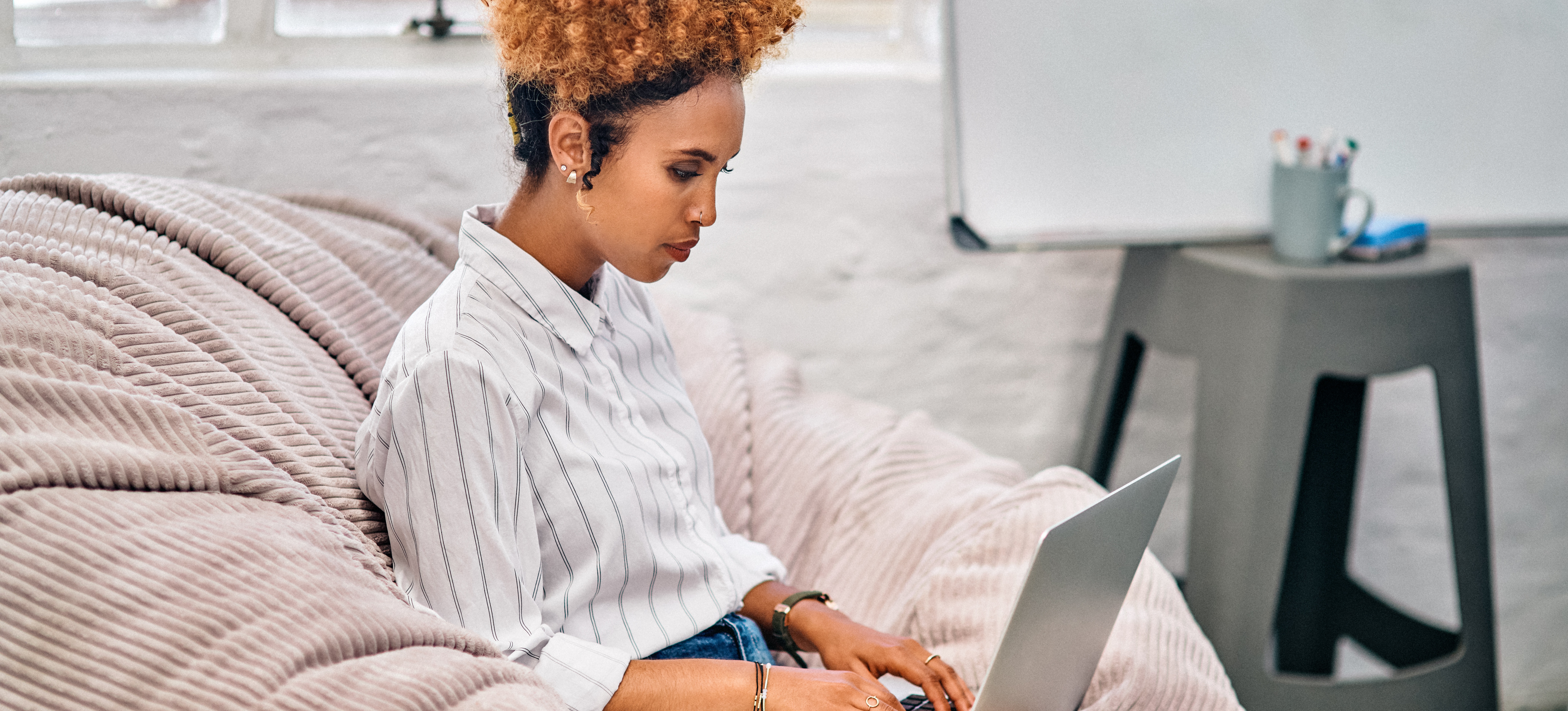 [Featured Image] An aspiring project manager uses her laptop to research, “What degree do you need to be a project manager?” 
