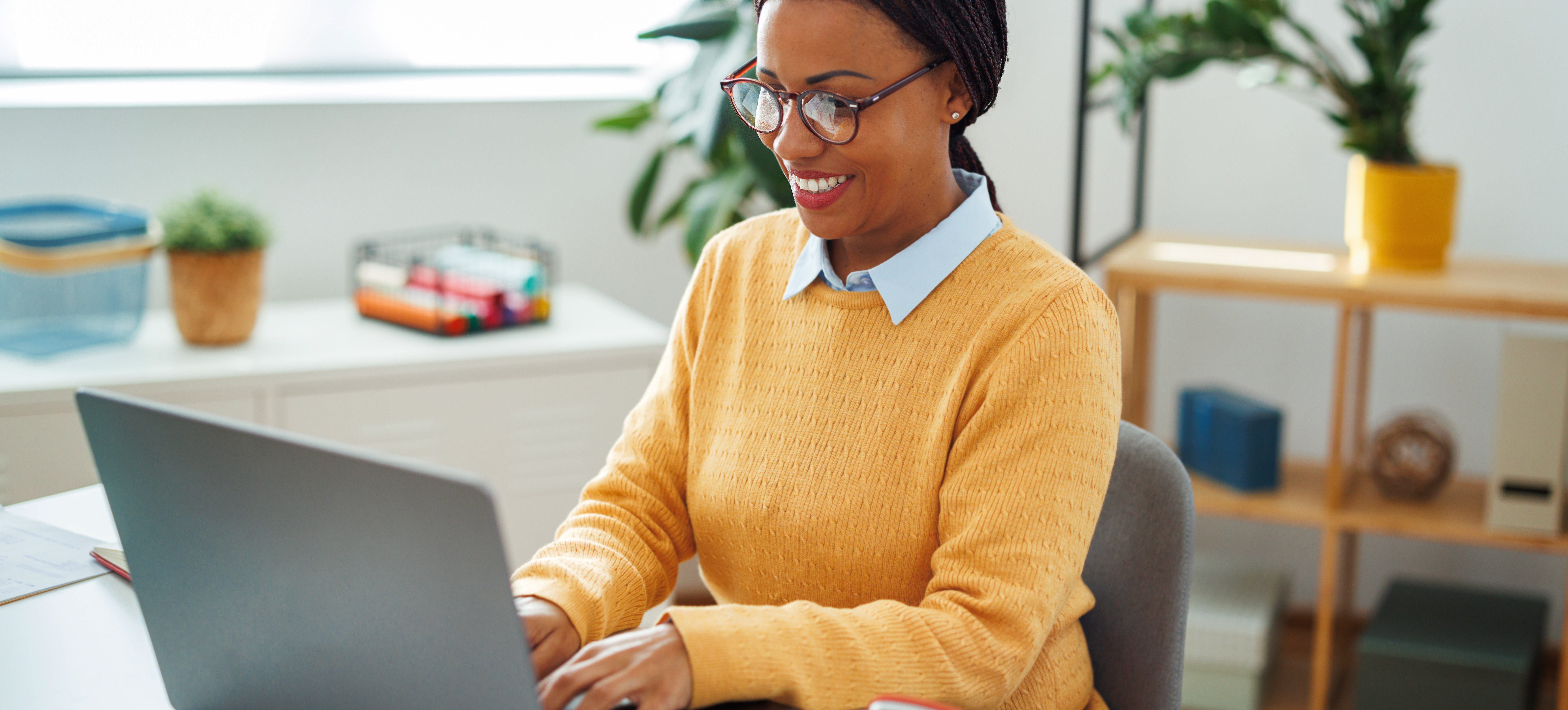 [Featured Image] A machine learning expert sits at a desk, using a laptop, and uses the softmax activation function.  