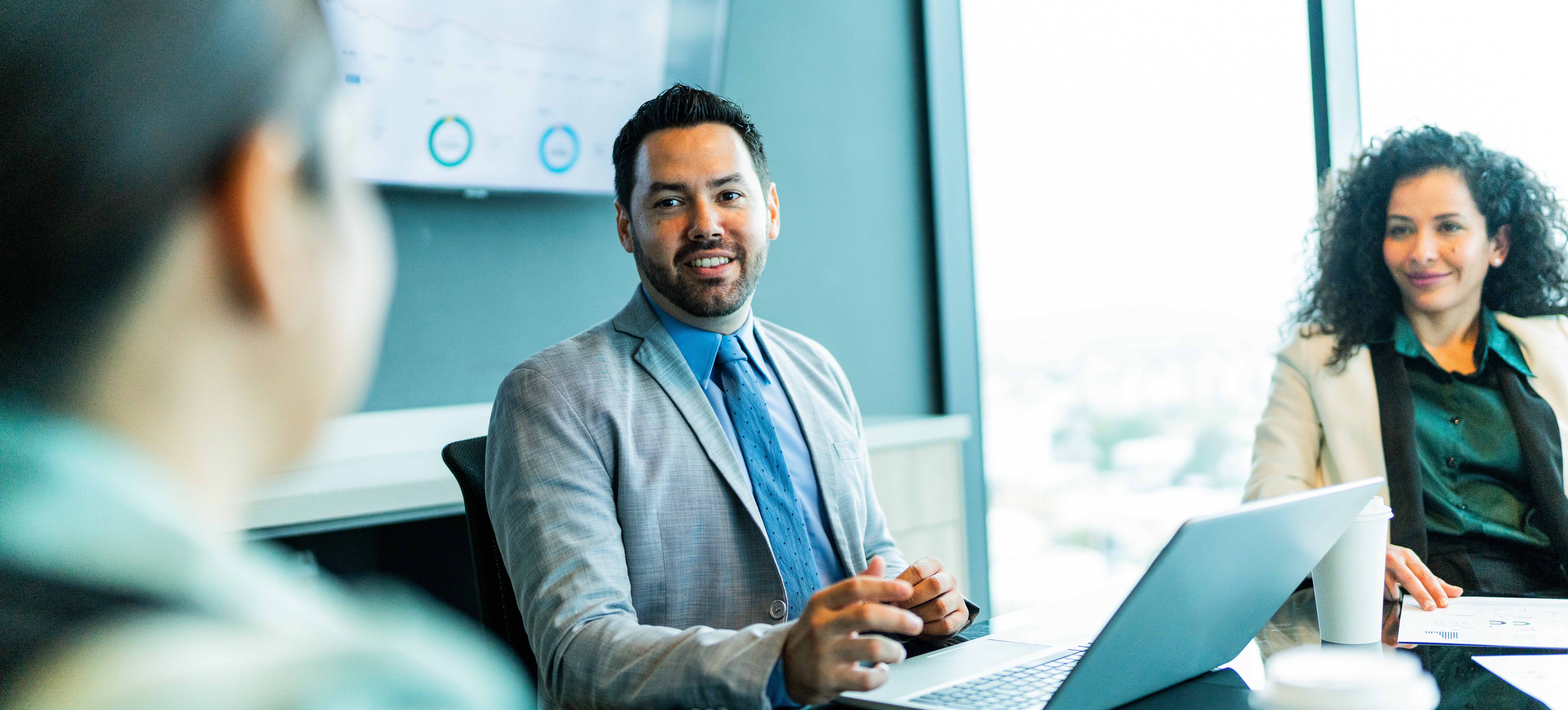[Featured Image] A machine learning engineer wearing a suit and tie answers large language models interview questions delivered by a panel of interviewers.
