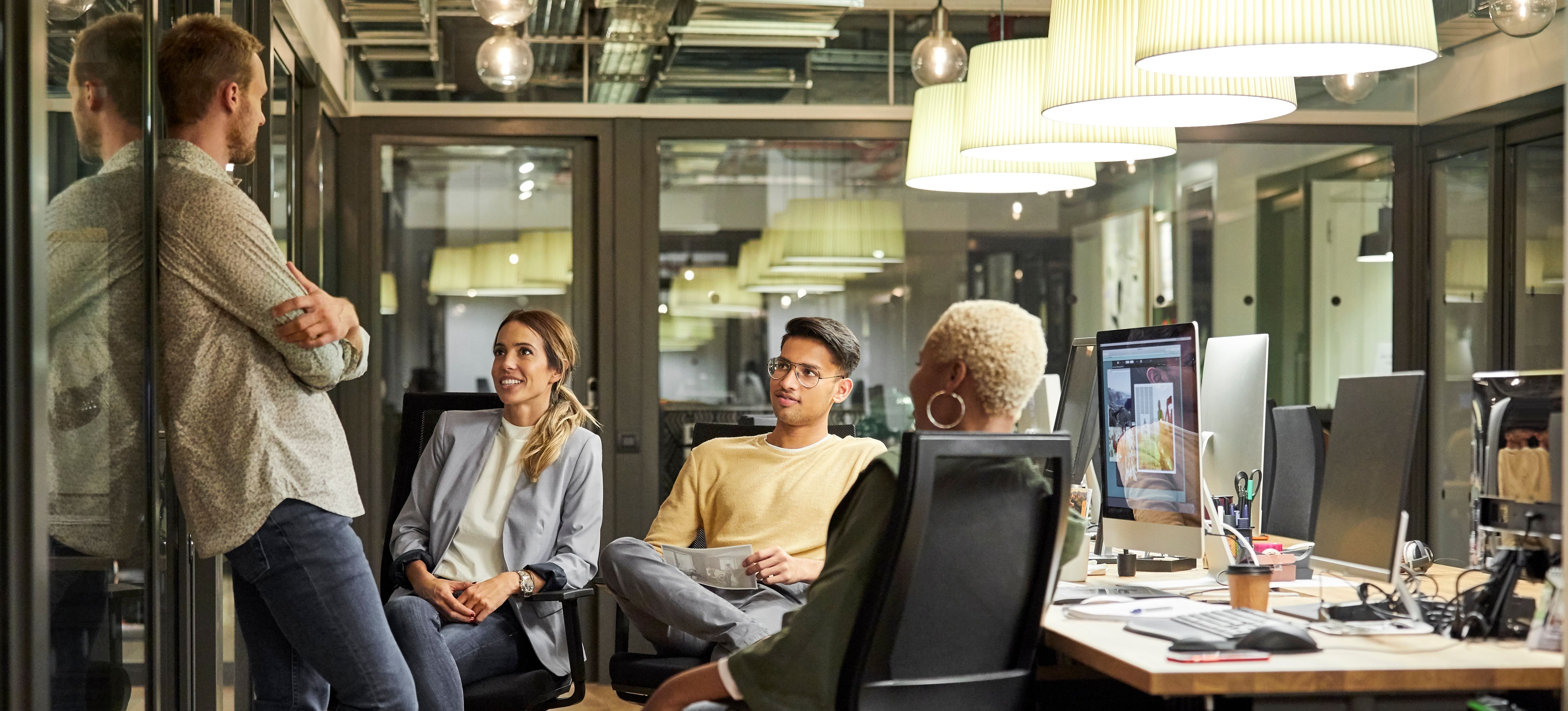 [Featured image] A group of cybersecurity engineers who are CISM certified have a discussion in a computer lab.