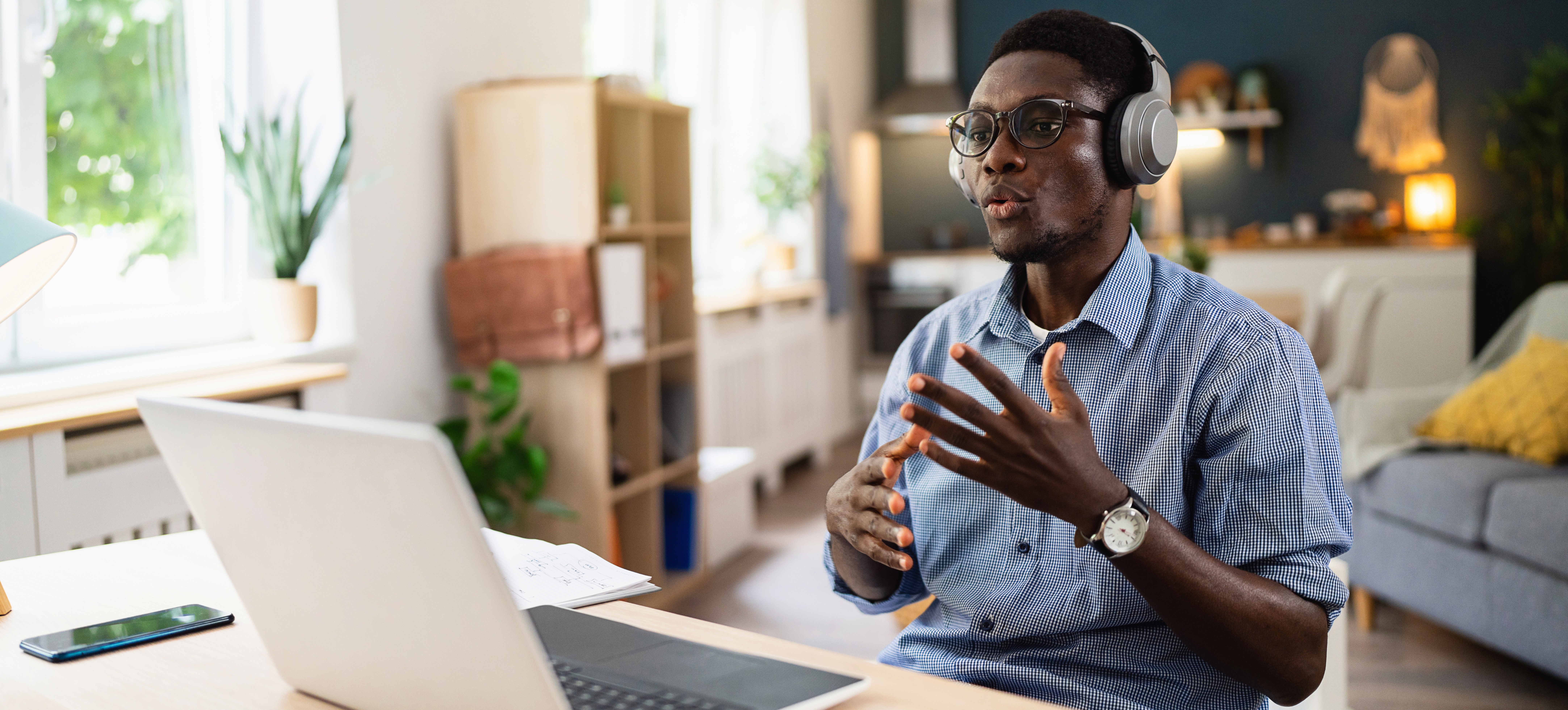 [Featured Image] A worker is sitting at their home office having a job interview for a full stack developer project.
