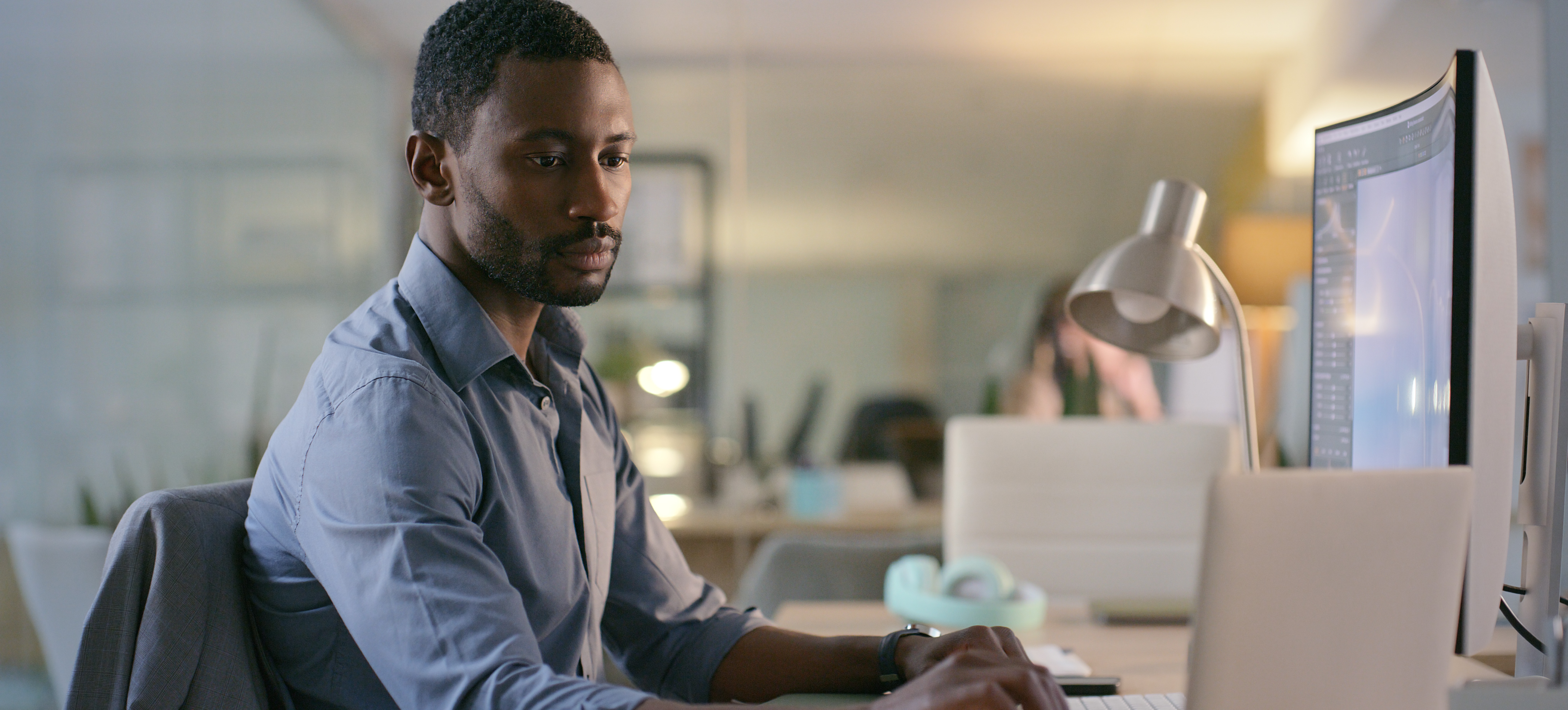 [Featured Image] A software engineer is on a computer using c programming to create a systems program.