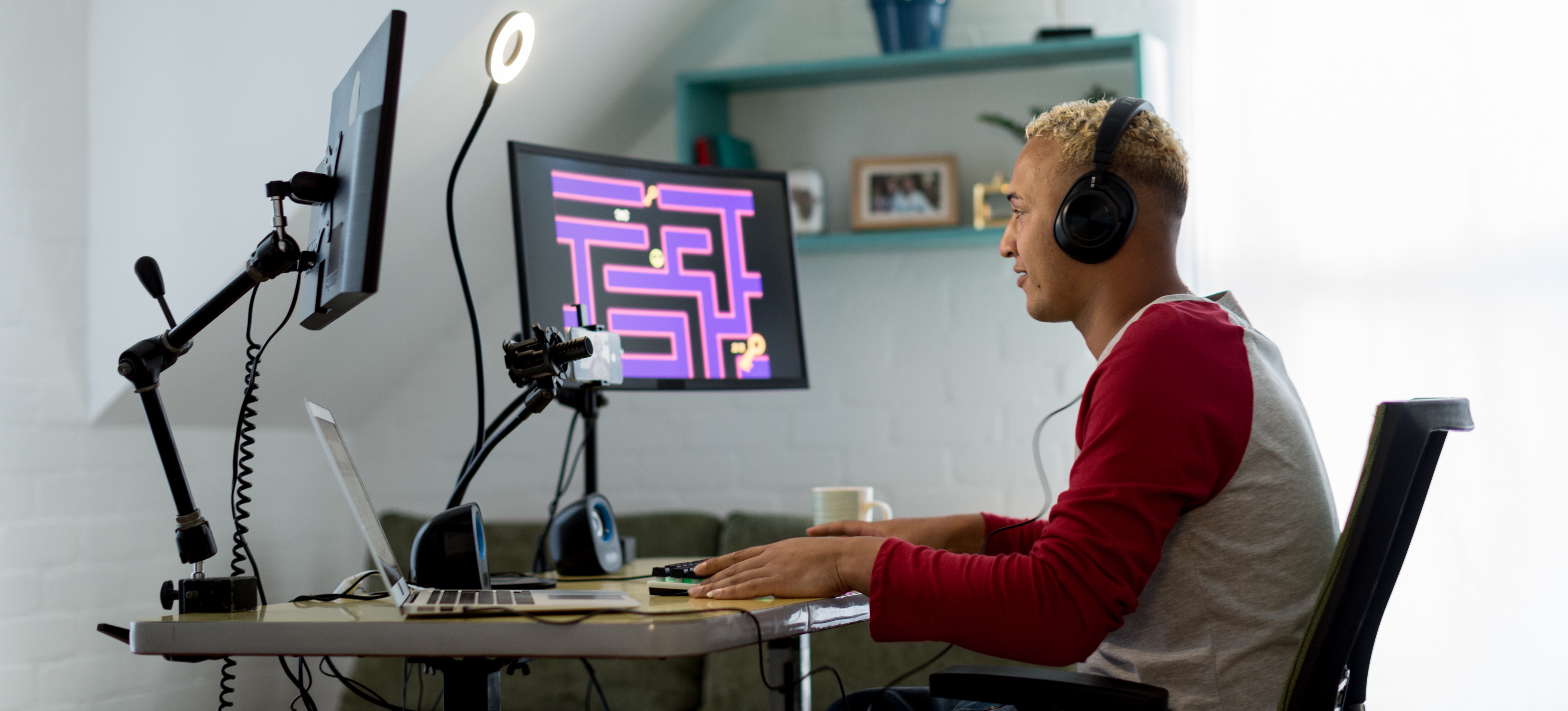 [Featured Image]: A game developer in a professional workspace, smiling while working on AI-driven game development.
