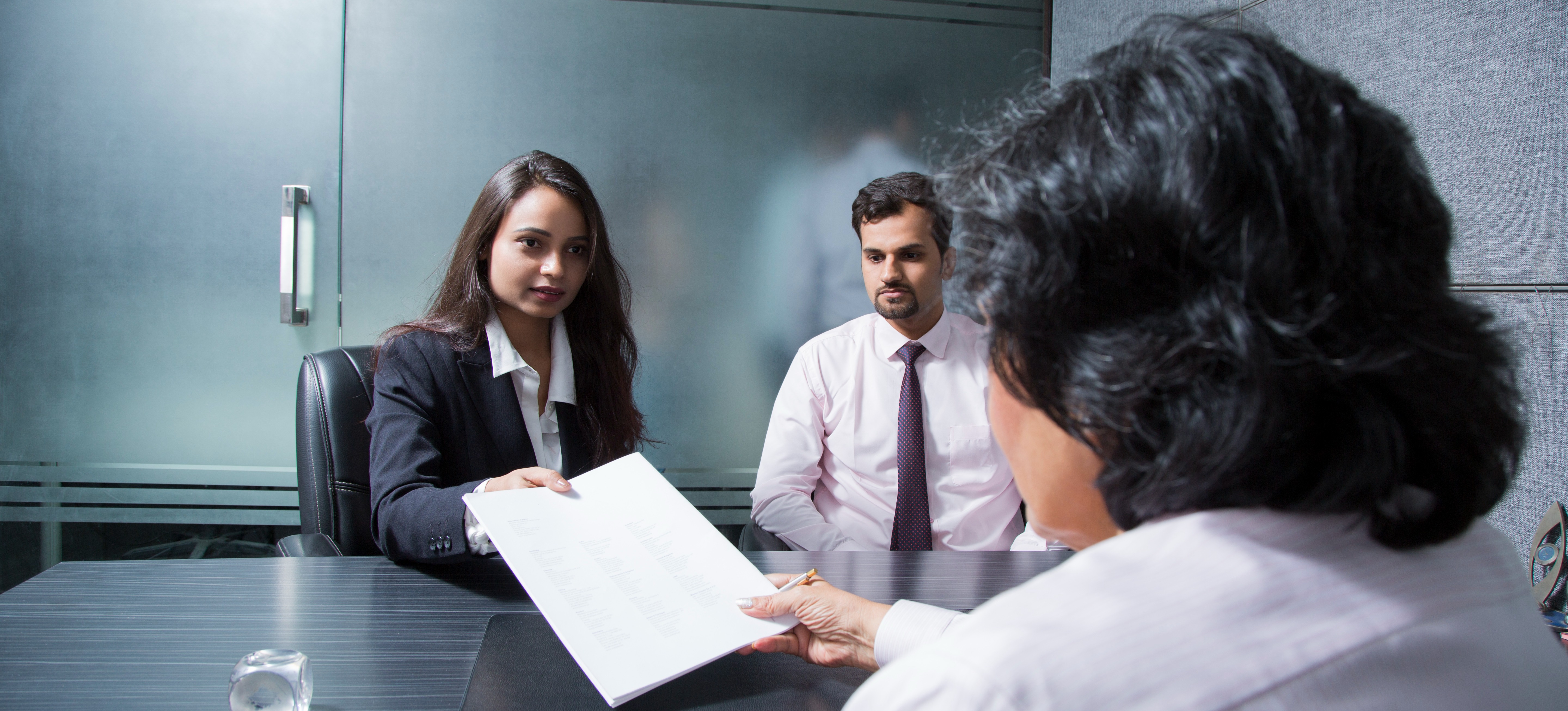 [Featured Image]: A professional shares their resume with a hiring manager after they spent time preparing for a career change.