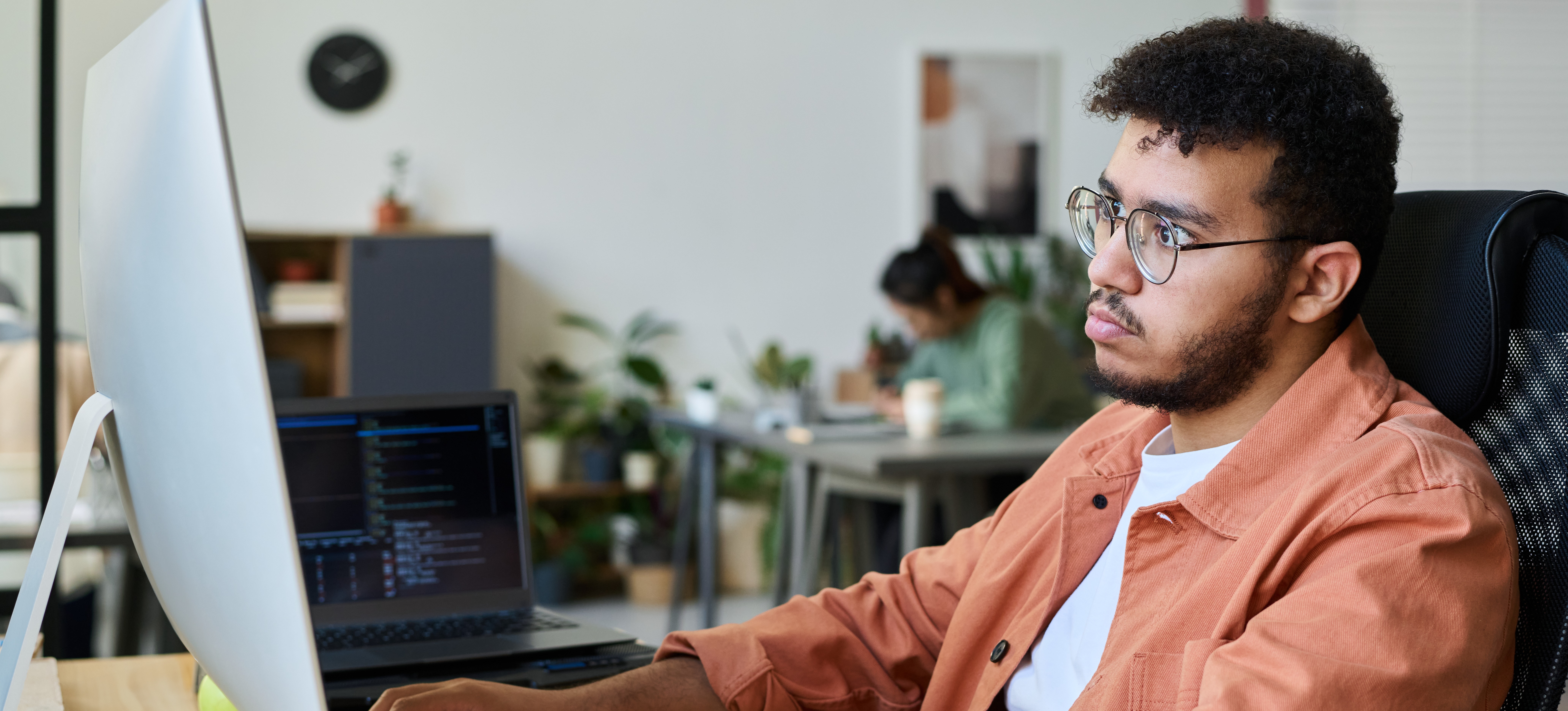 [Featured Image] A developer works at a computer, building a progressive web app.
