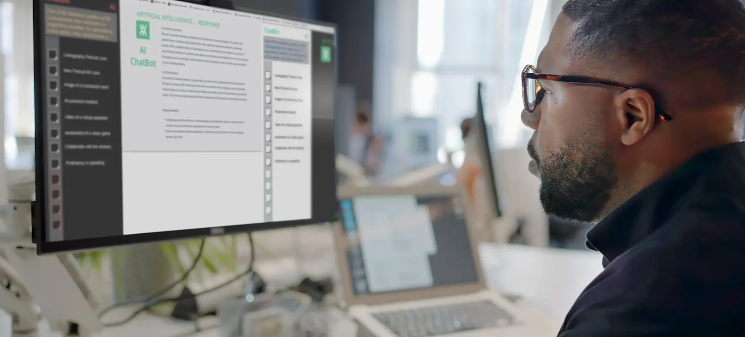 [Featured Image] A business intelligence analyst looks on as type is being added to a computer screen by an AI chatbot.
