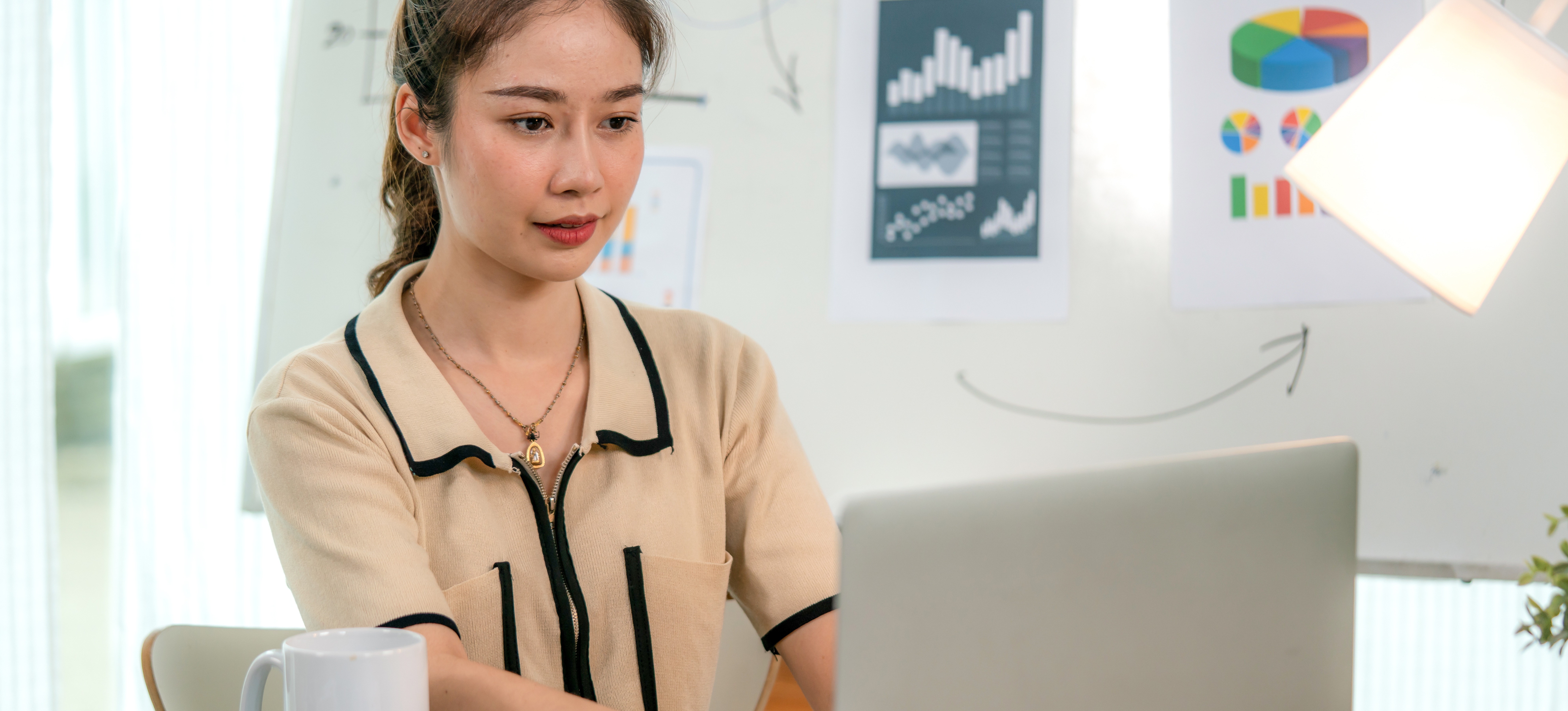 [Featured Image] A data scientist sits with their laptop, using stemming to simplify data. 