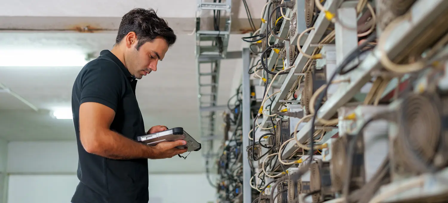 [Featured Image] A blockchain engineer is checking the network integration and security of a software.