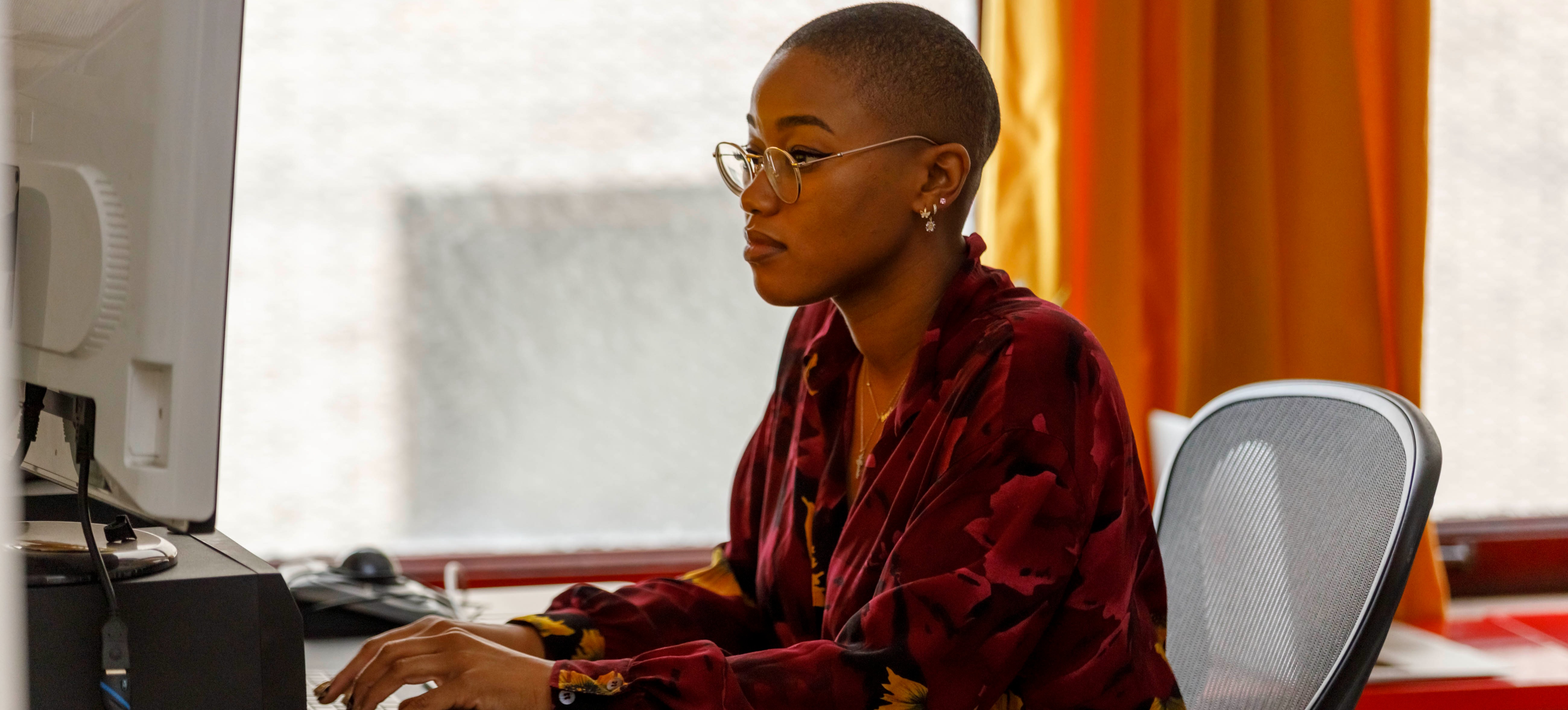 [Featured Image] An SEO specialist works at a computer, making a local SEO strategy.
