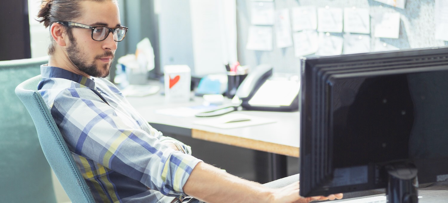 [Featured Image] A computer vision professional is programming on a computer to allow patterns and features in visual data to be recognized by AI.
