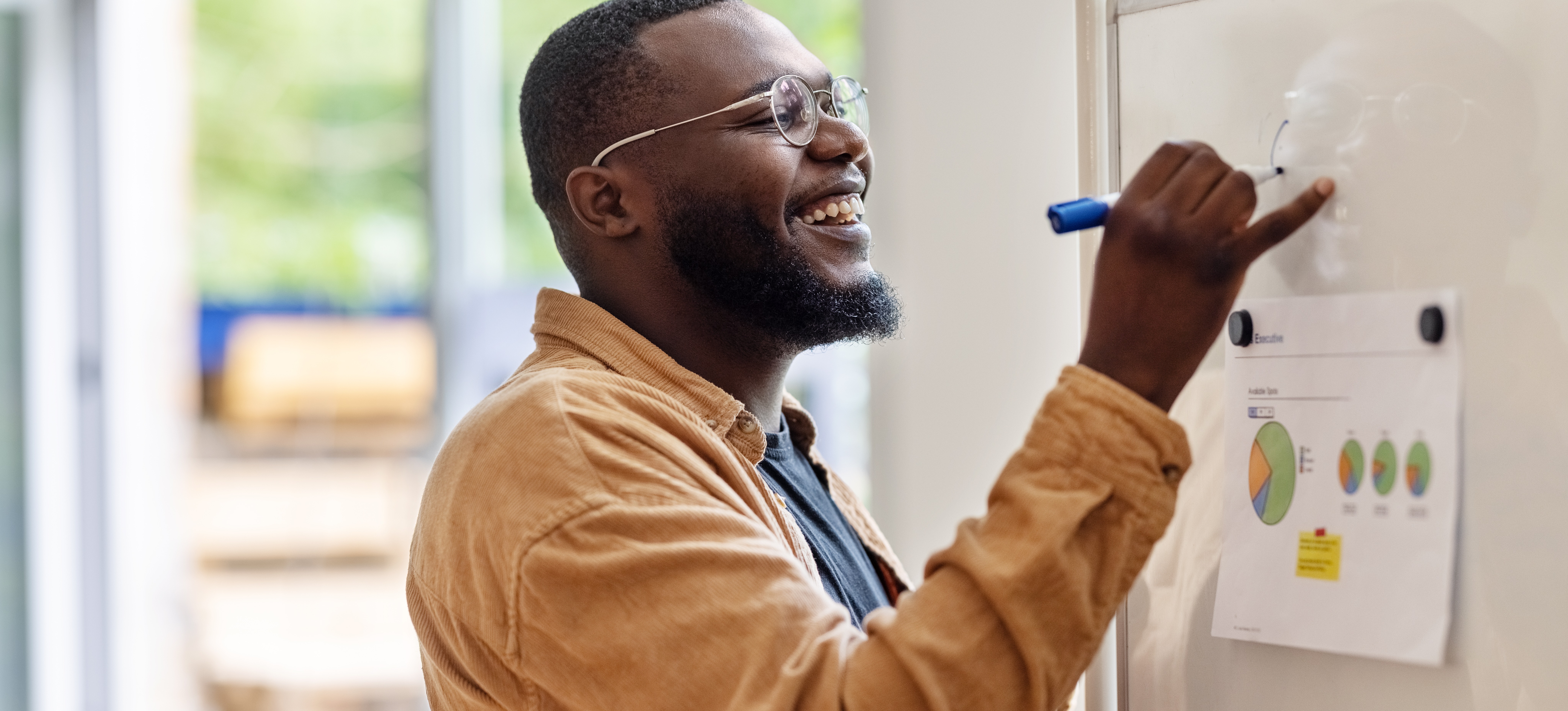 [Featured Image] A data scientist, which is one job you can do with a math degree, writes on a white board. 