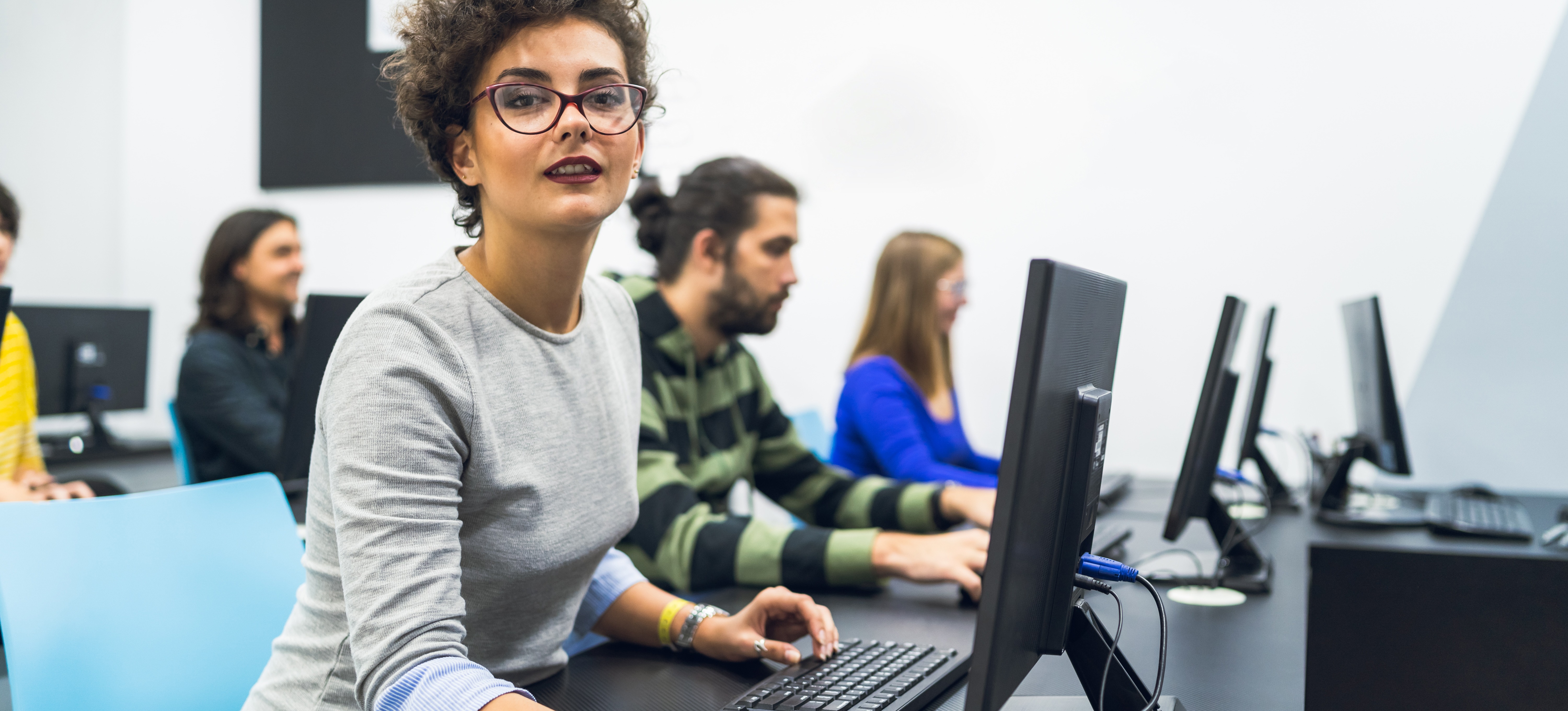[Featured image] An aspiring software developer takes a programming class in a computer lab.